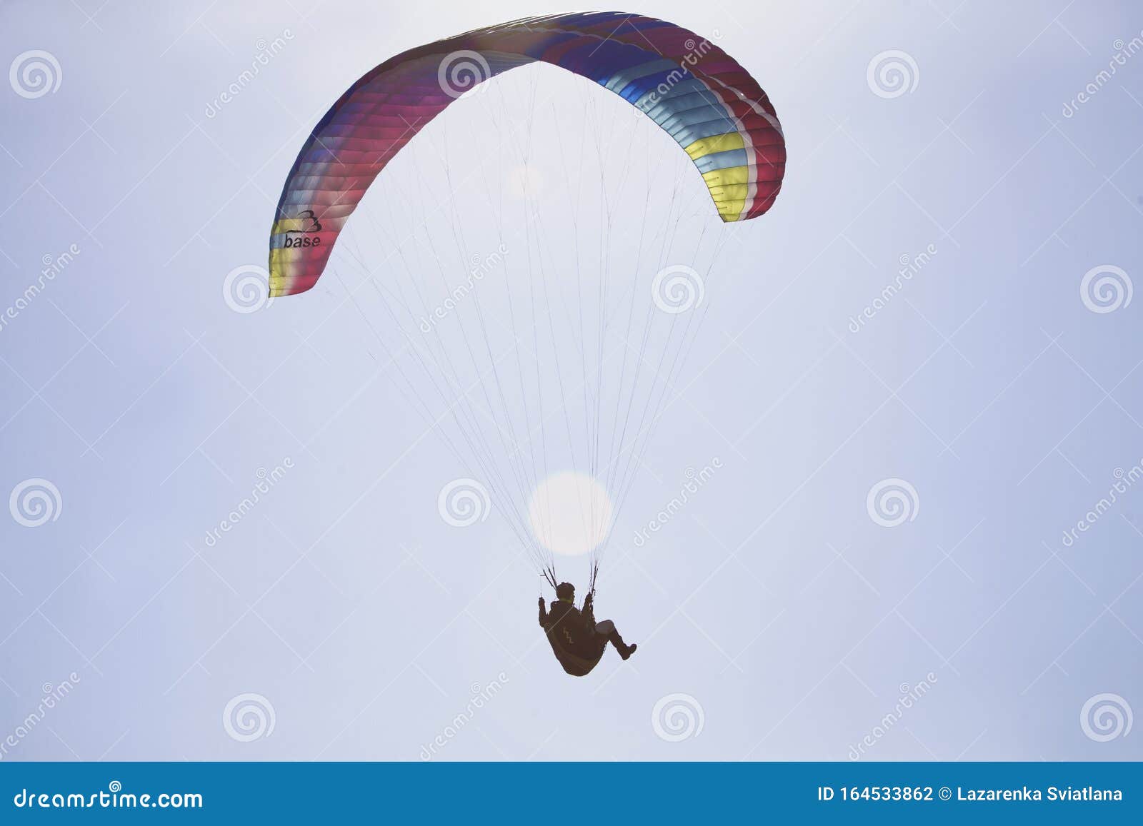 Performances On Paraglidinga Paraglider Flies In The Sky Under A Multi