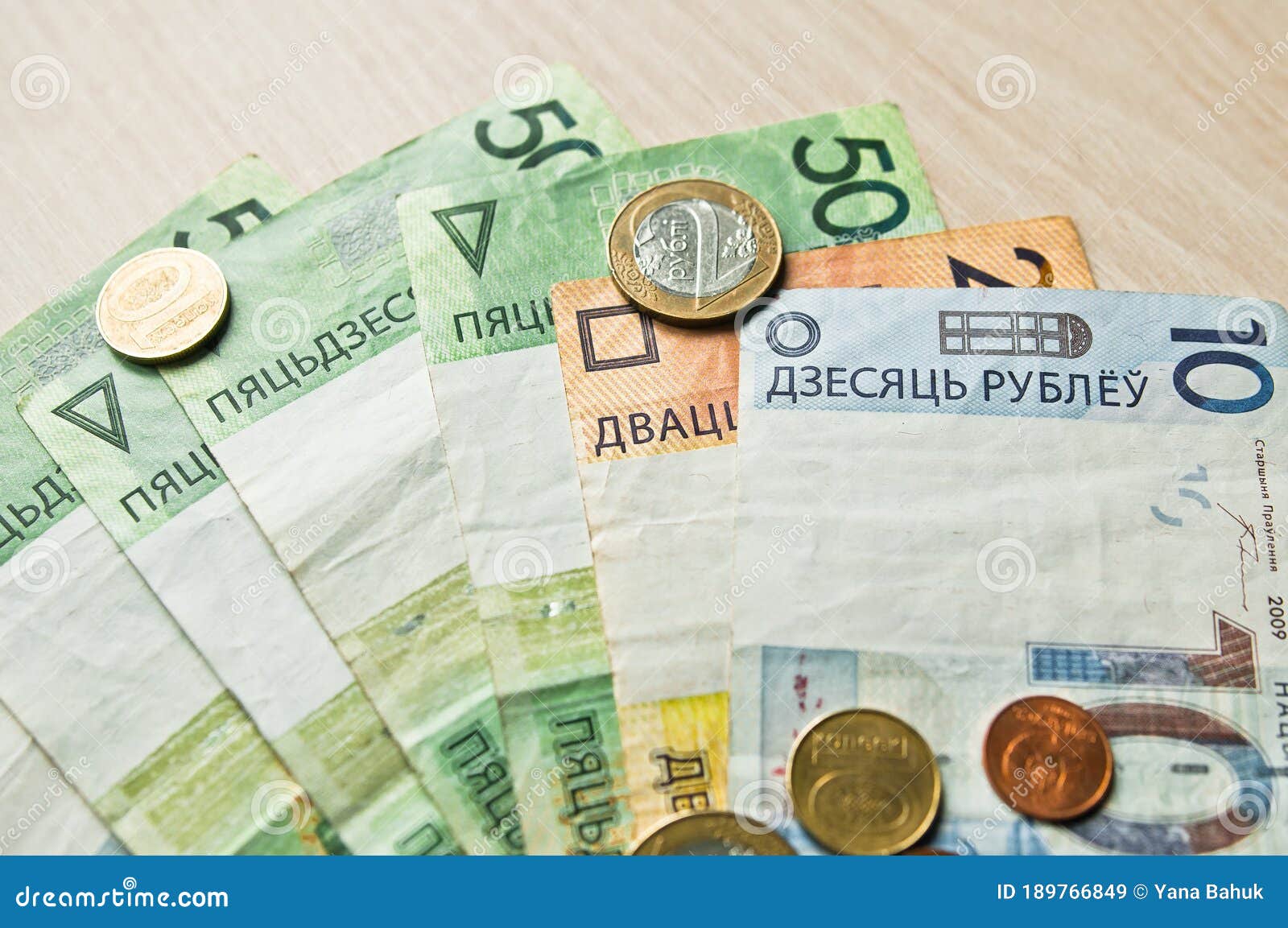 belarusian rubles and coins on a colored background