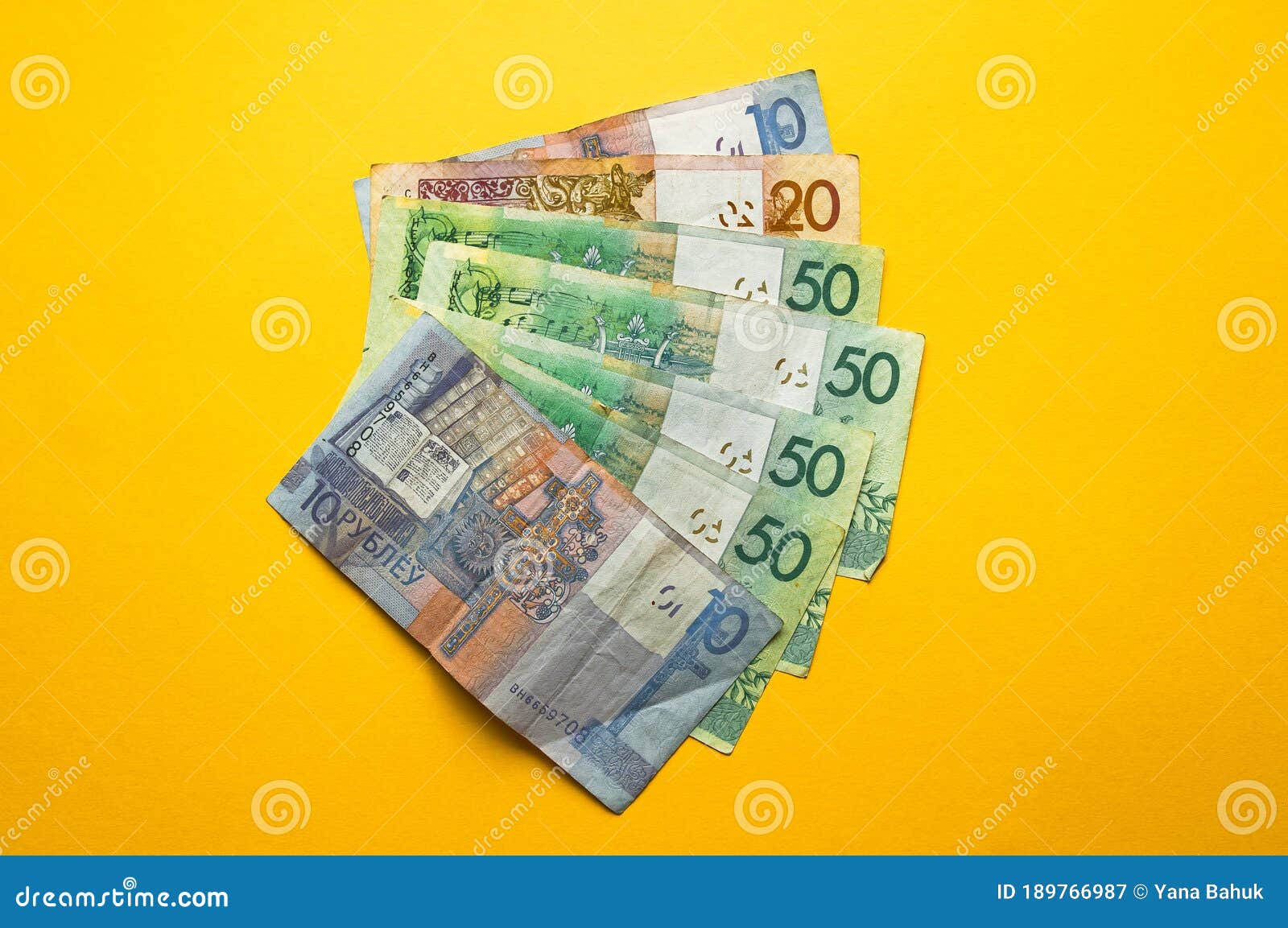 belarusian rubles and coins on a colored background