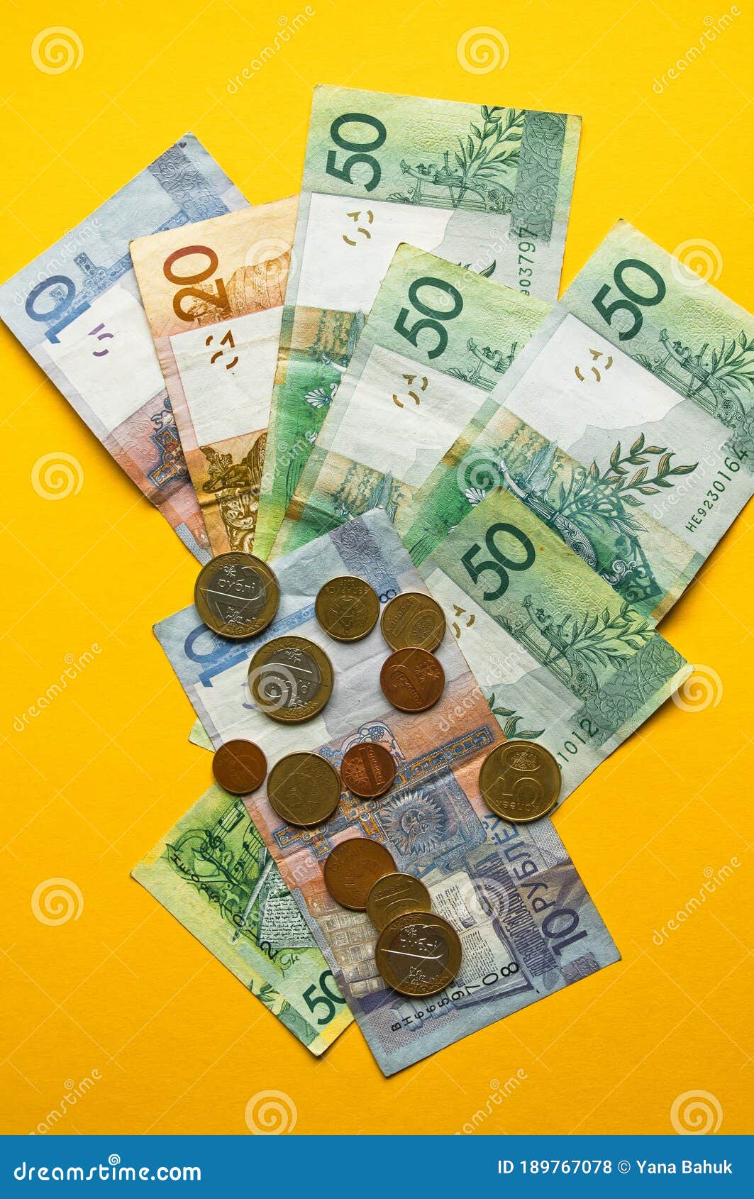 belarusian rubles and coins on a colored background