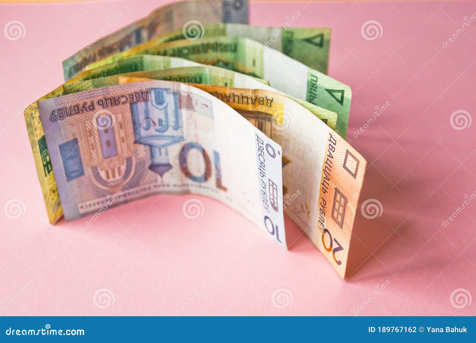 belarusian rubles and coins on a colored background