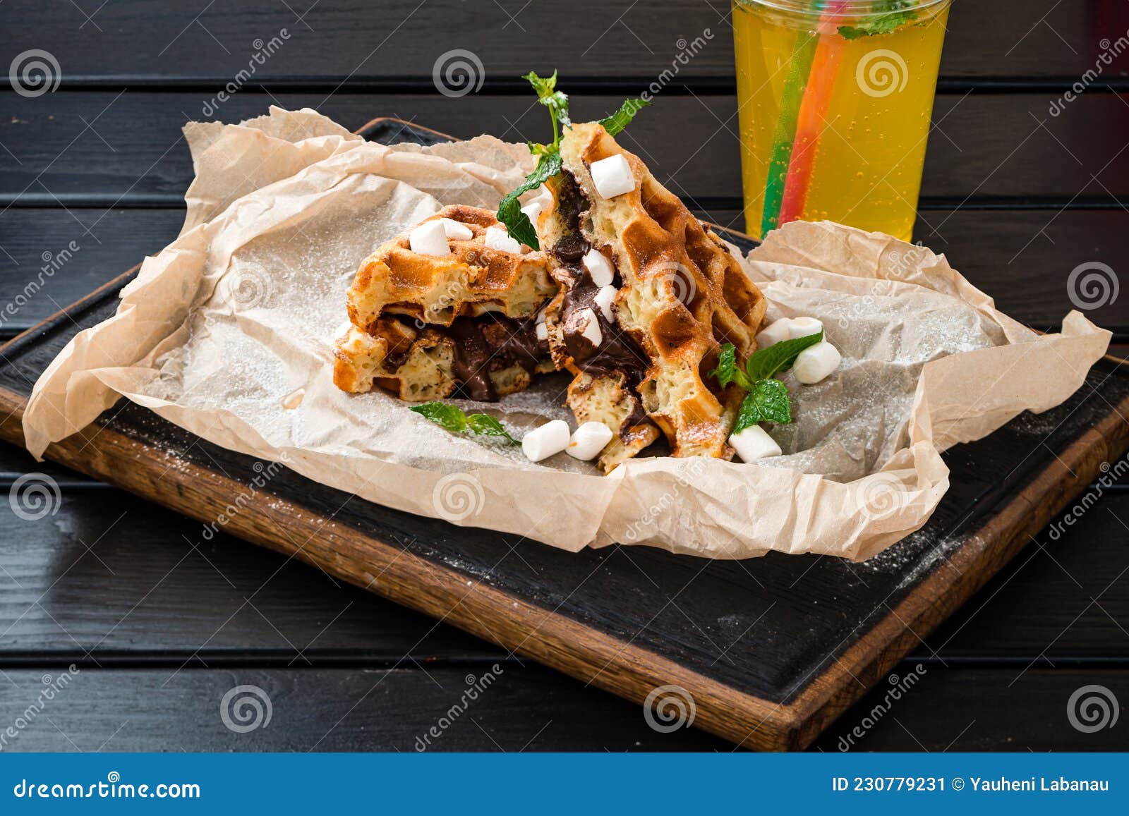 Belgian Waffle with Marshmallows and Chocolate on Dark Background Stock