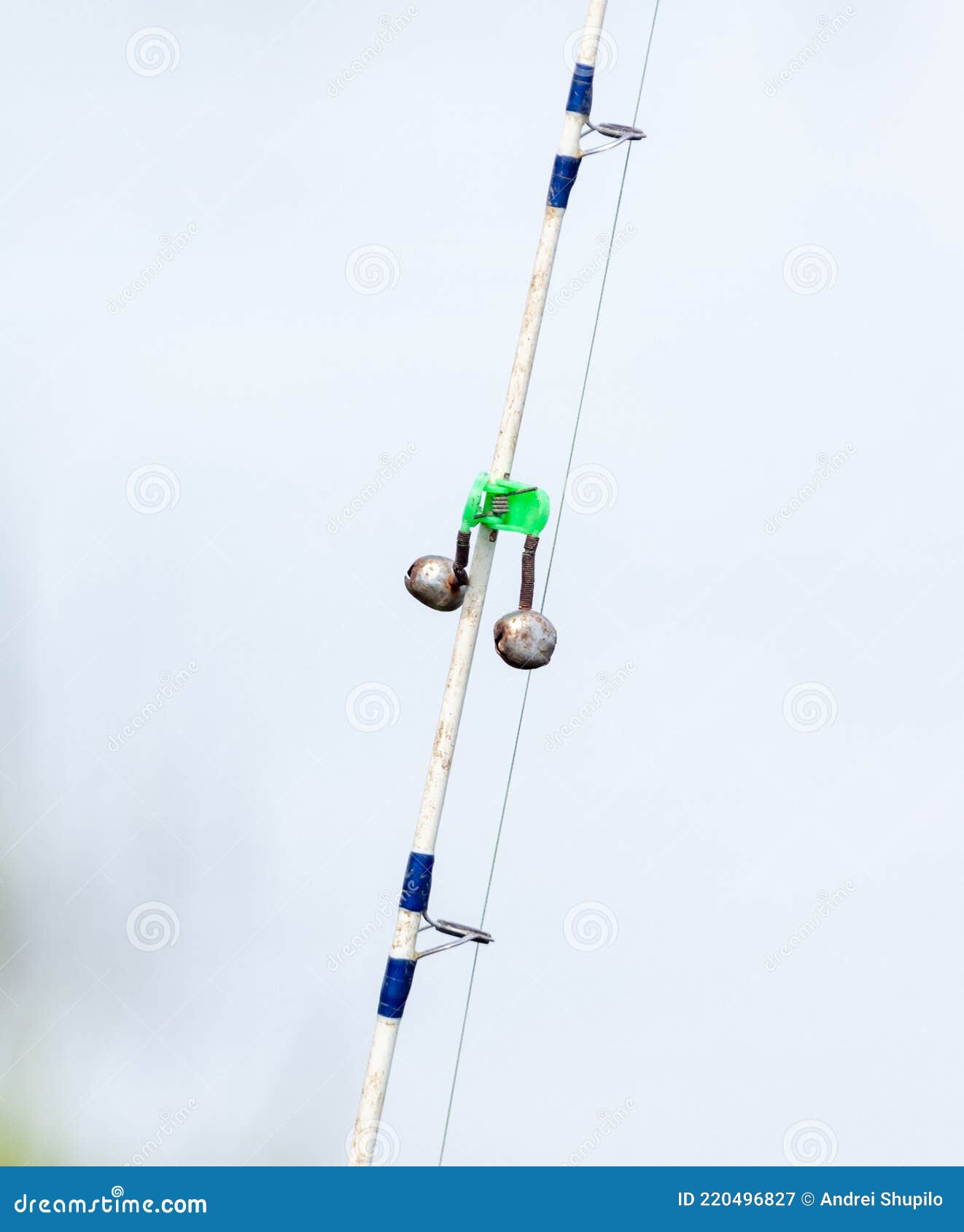 A bell on a fishing rod. stock image. Image of jingle 220496827