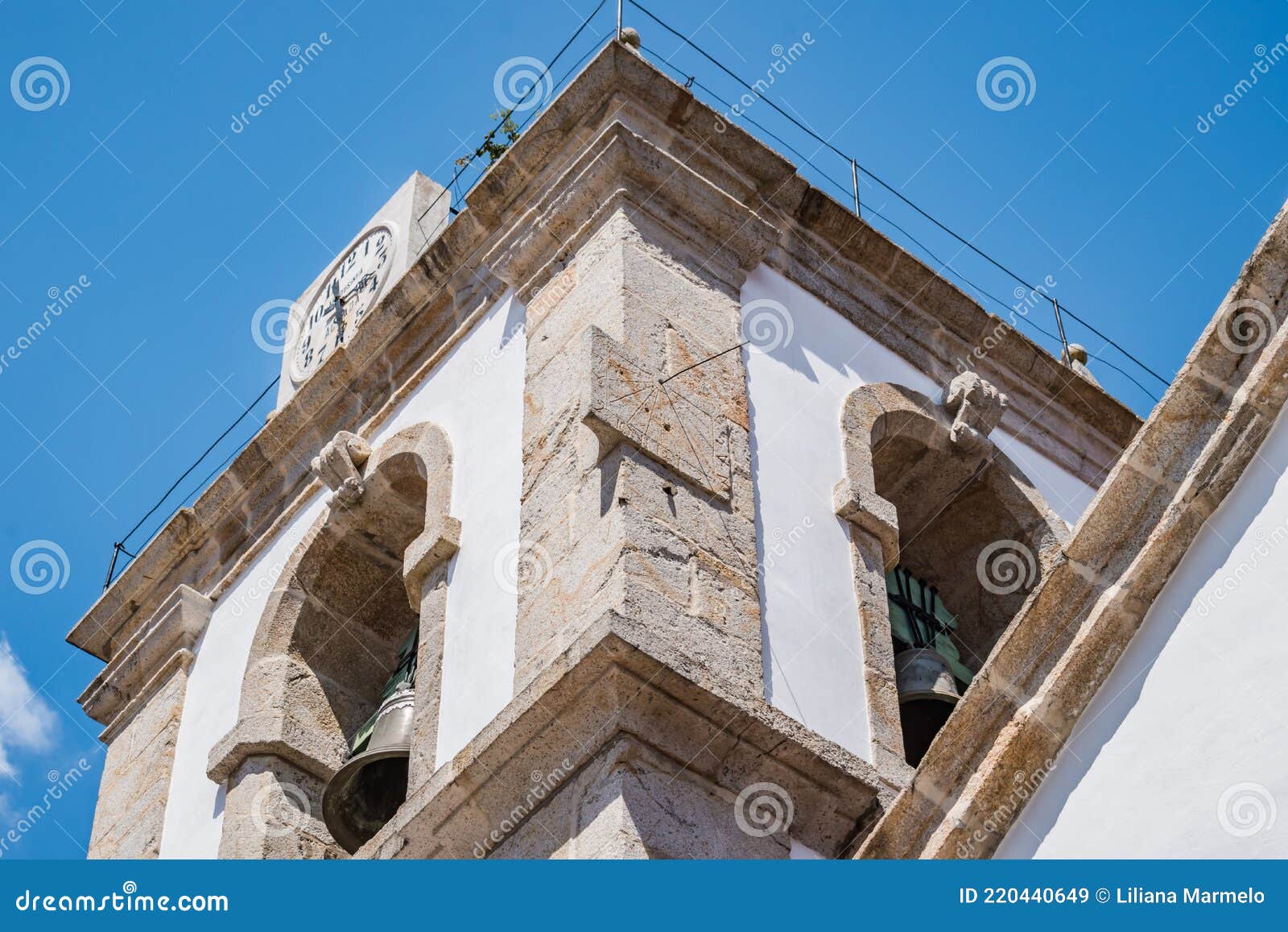 perspective of church bell tower with stone clock and sundial, pedrogÃÂ£o pequeno portugal