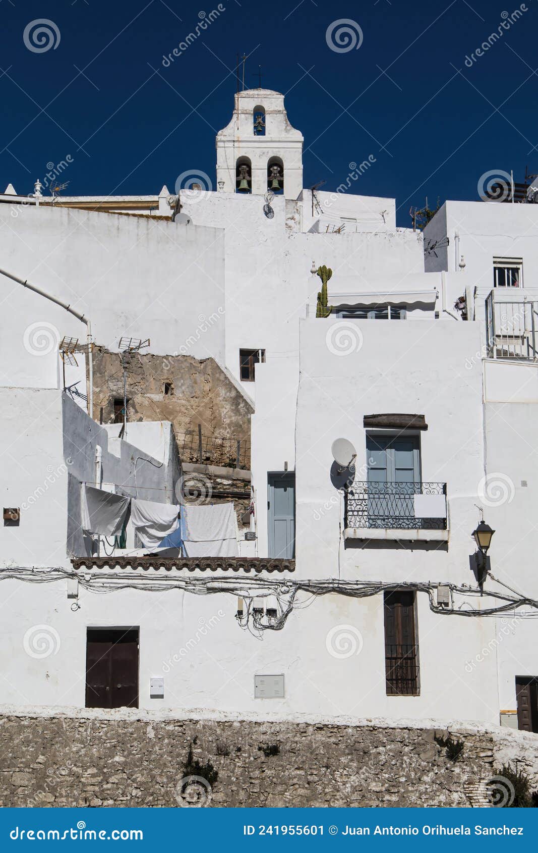 bell tower and white houses in vejer de la frontera, spain