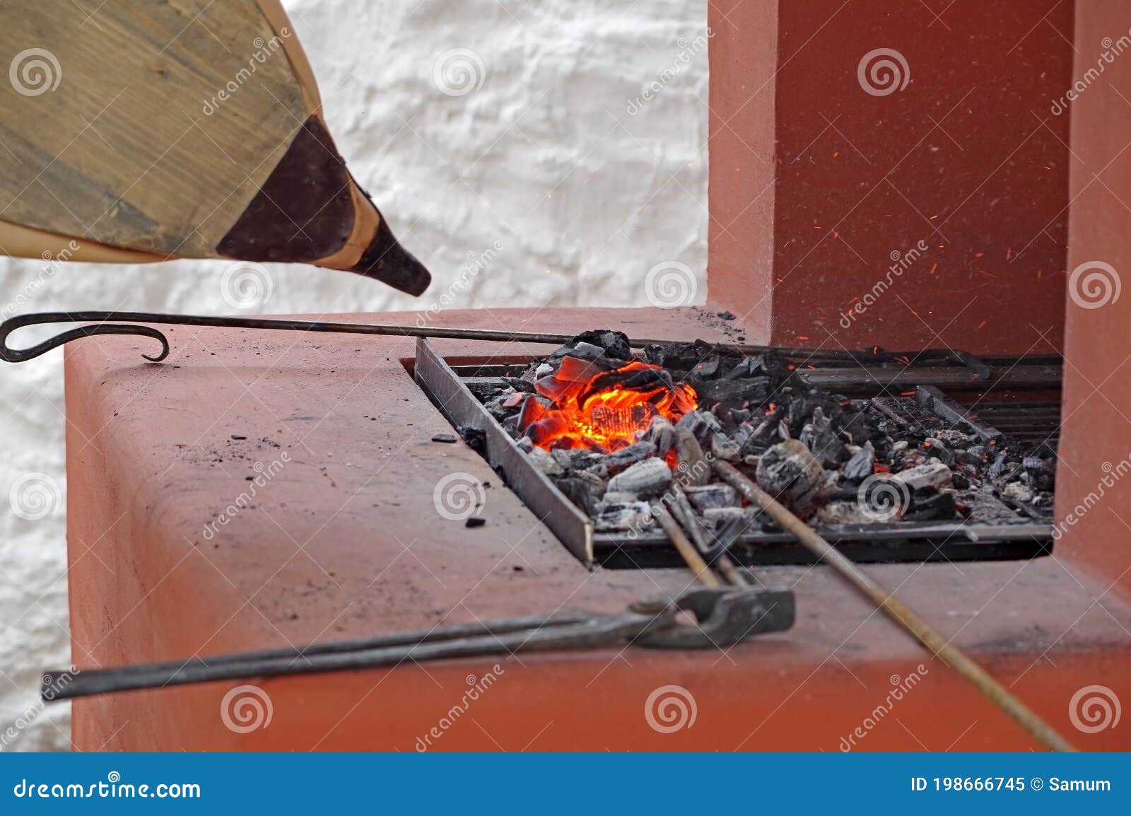 Bellows of the Blacksmith Fanning the Fire in the Coals Stock Image