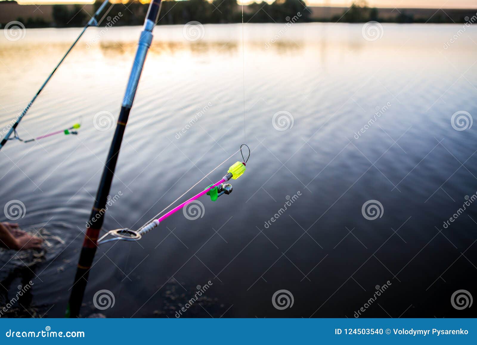 Bells for Fish Bites on Fishing Rod Against Background of Lake