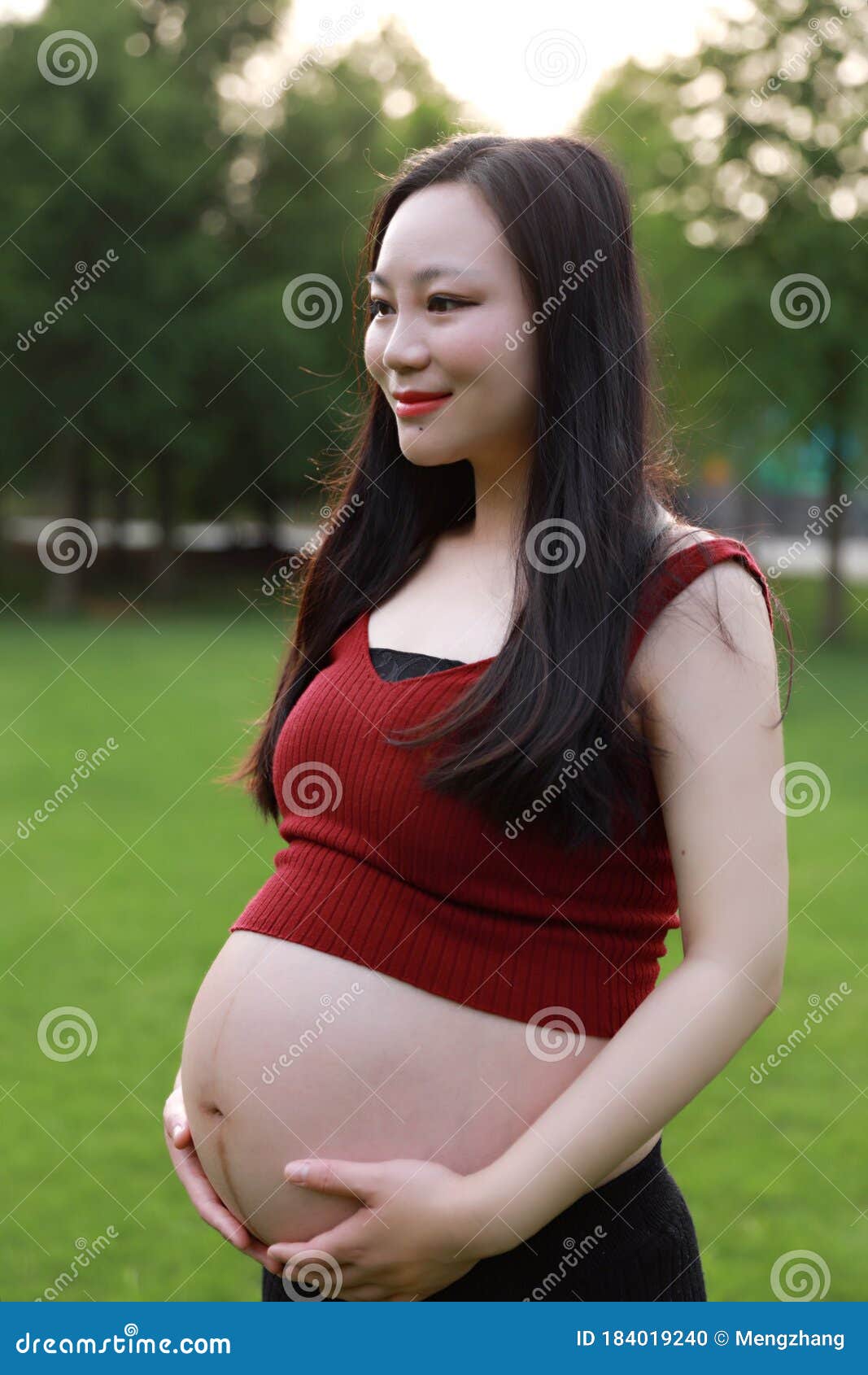 Belly Closeup Asian Pregnant Woman In Garden Forest Law