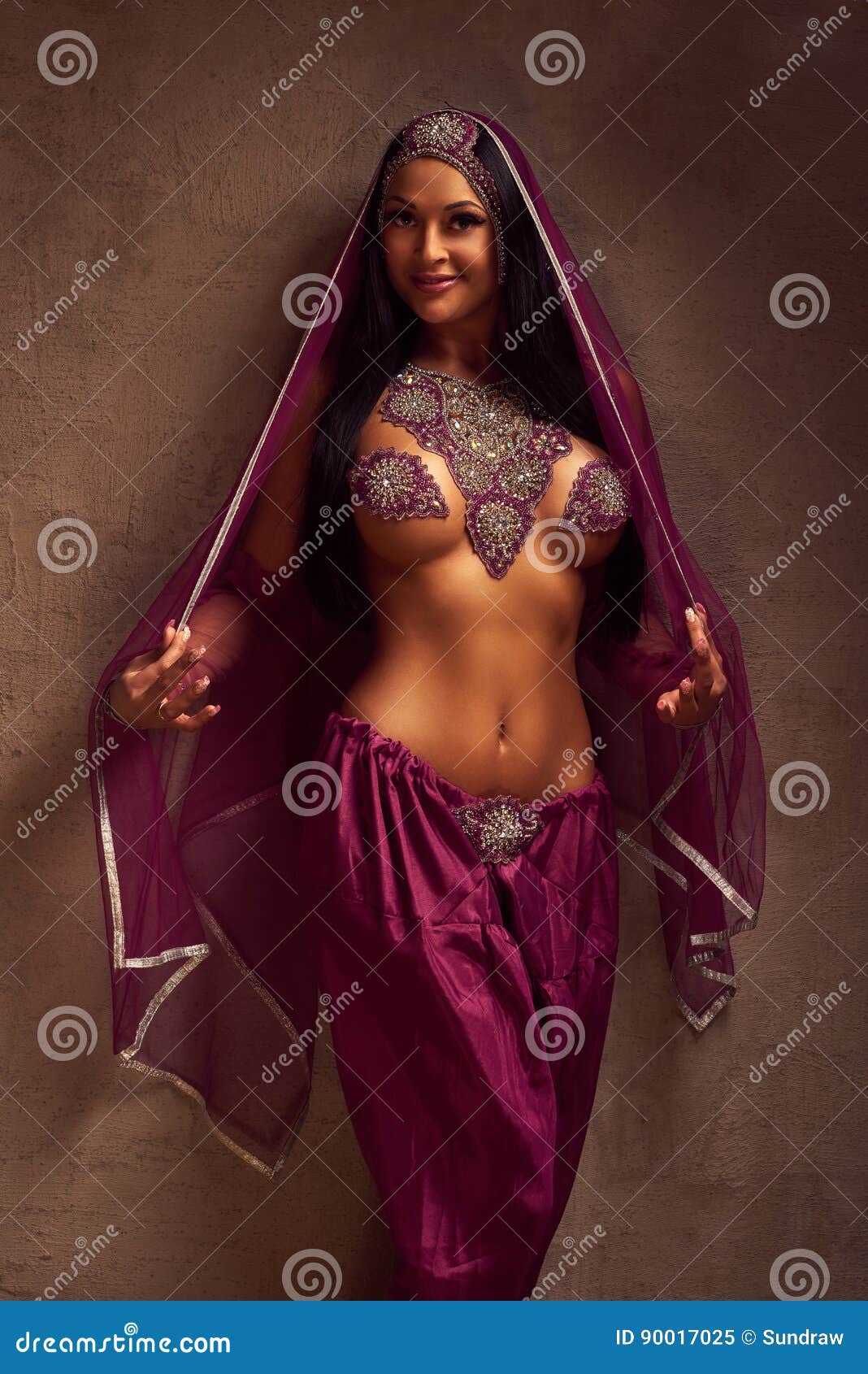 belly-dancer woman in afghani pants, purdah and adornment