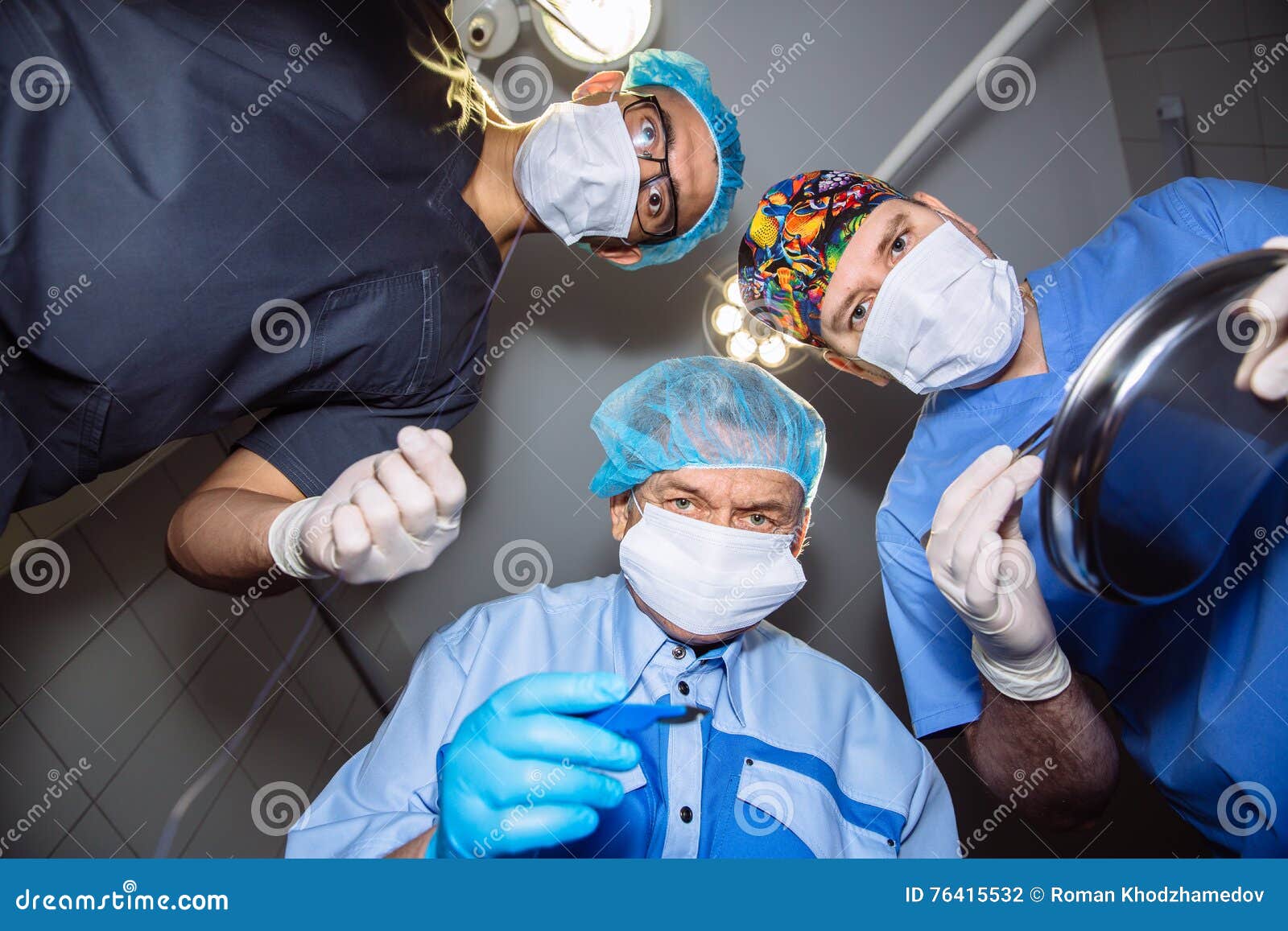Below View of Surgeons Holding Medical Instruments in Hands. Concept a