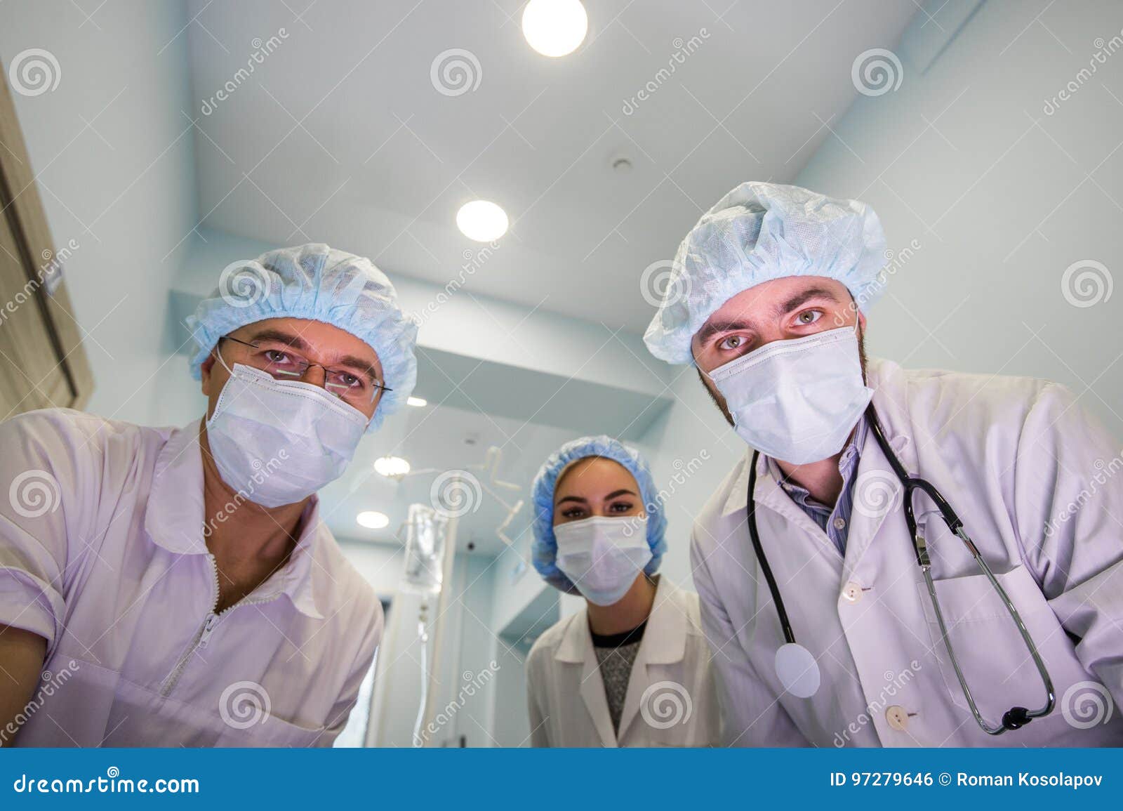 Below View of Surgeons Holding Medical Instruments in Hands and Looking