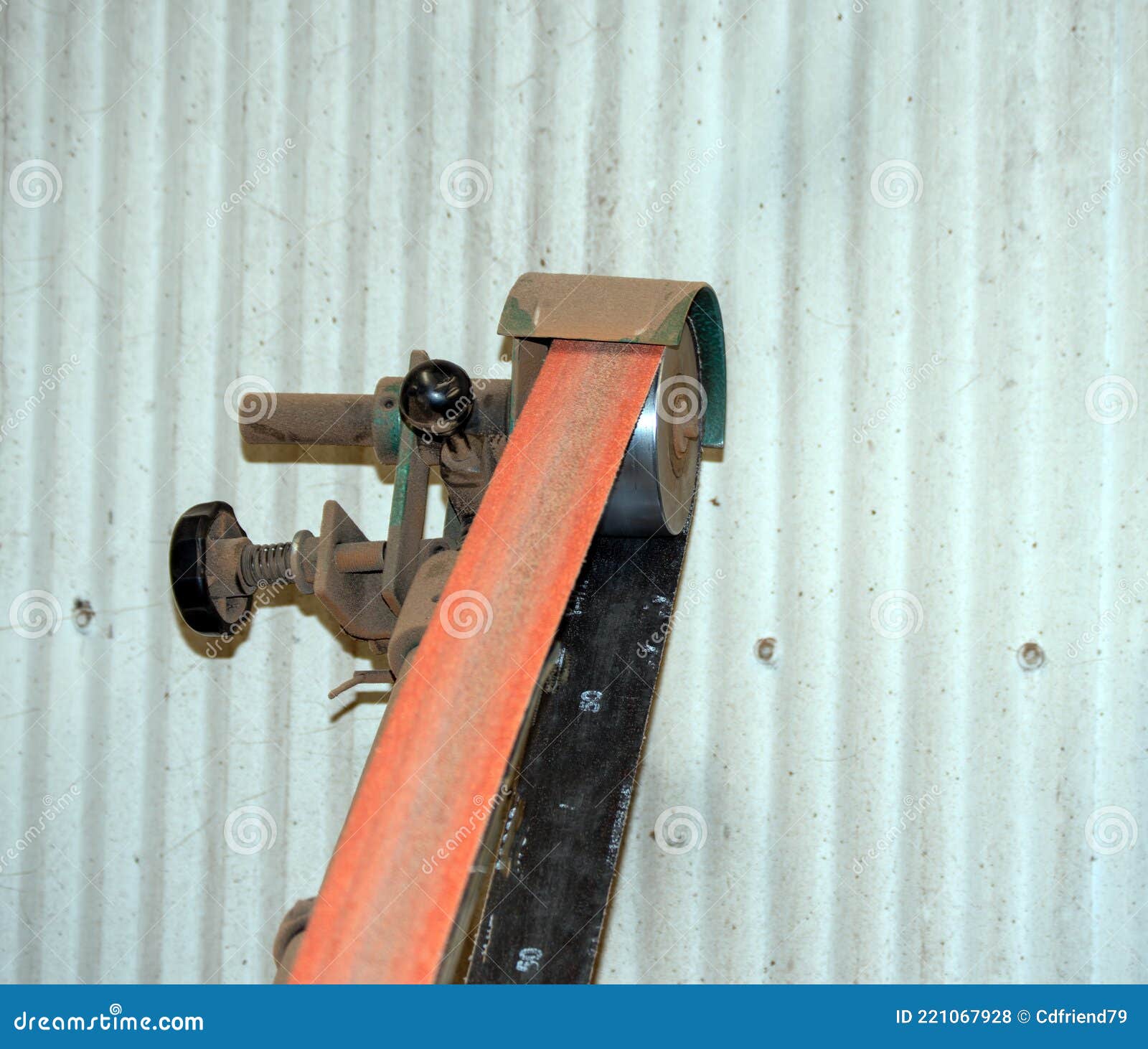 a belt grinder in the workshop.