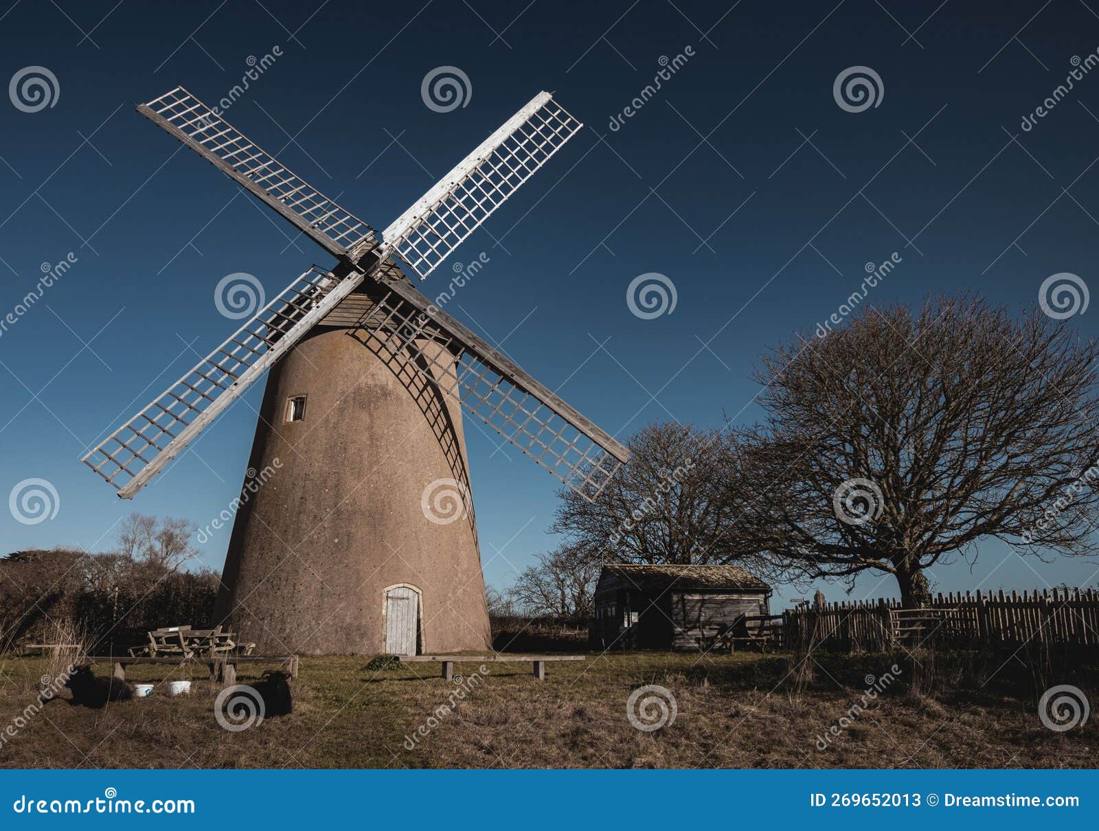 Bembridge Windmill Standing on a Vast Meadow, with a Cloudless Sky