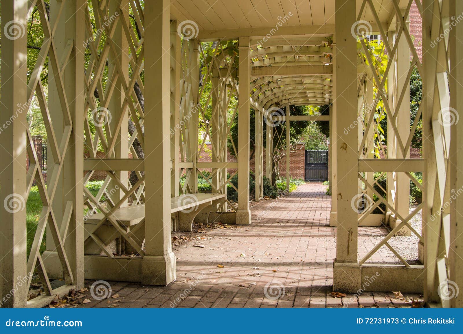 Bench Seat Under a Wooden Archway on Brick Path Stock Image Image of