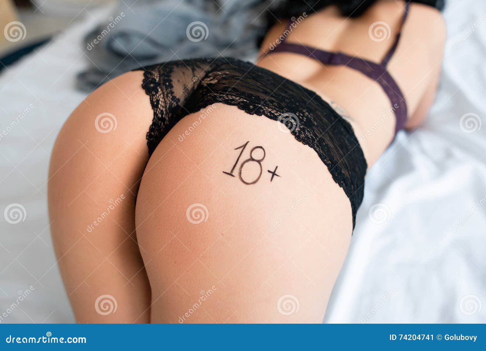 Bending Woman in Bed with Label 18plus on Stock Image