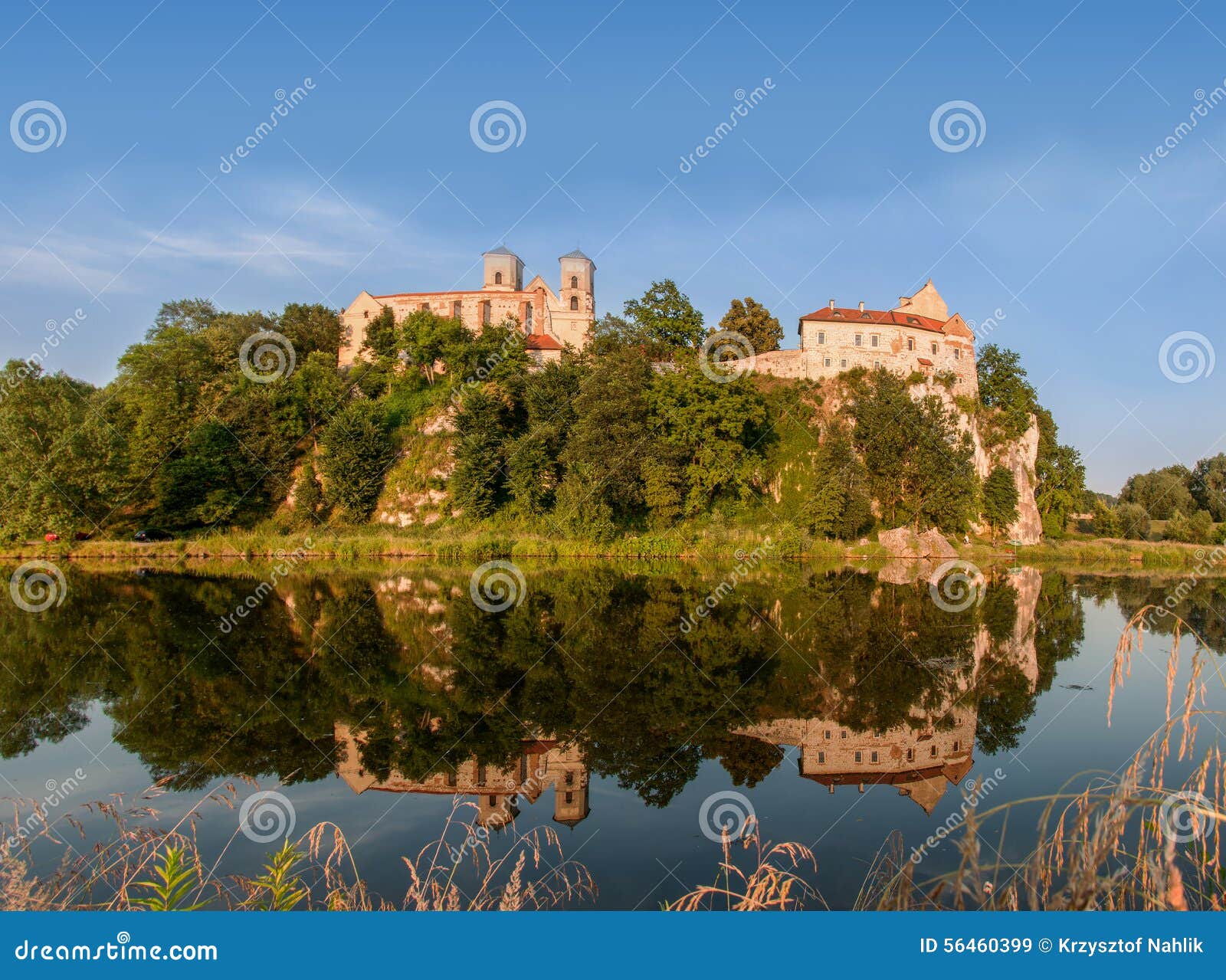 Benedictine abbey in Tyniec, Krakow, Poland. Benedictine monastery on the rocky hill in Tyniec near Cracow, Poland and its reflection in Vistula River at sunset.