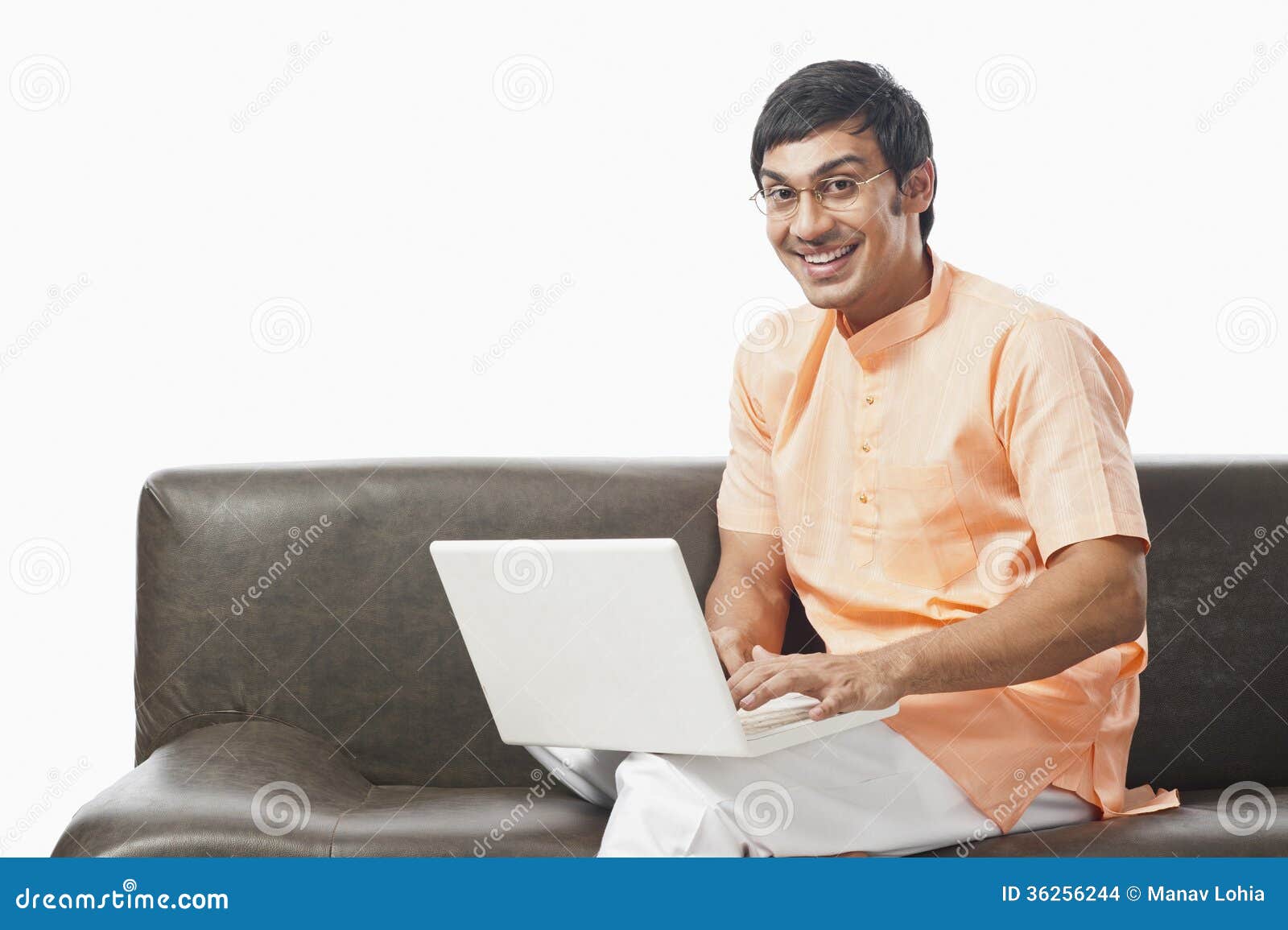 Bengali Man Using a Laptop on the Couch Stock Photo Image of