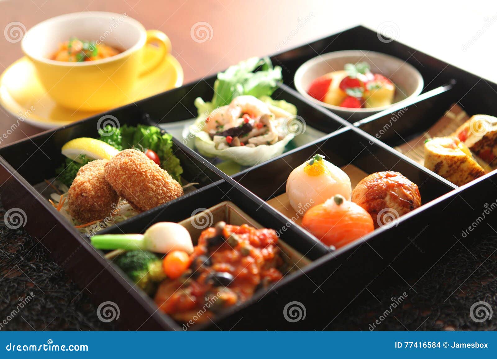 bento of temari sushi, shrimp and marinated mushrooms, egg grill