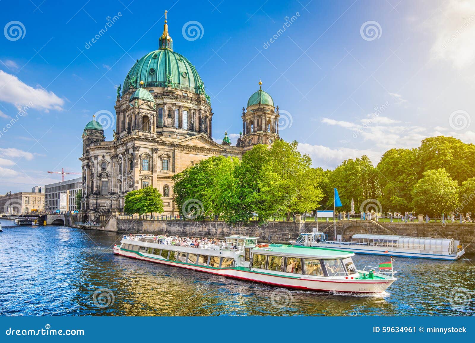 berlin cathedral with boat on spree river at sunset, germany