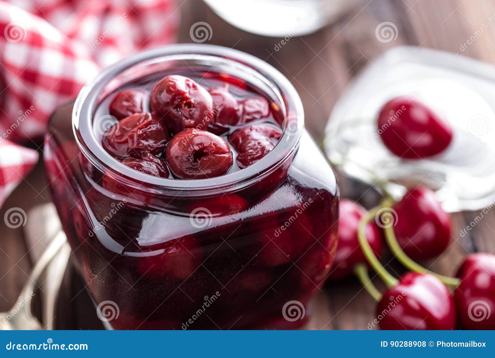 Berries Cherry with Syrup in a Glass Jar. Canned Fruit Stock Photo
