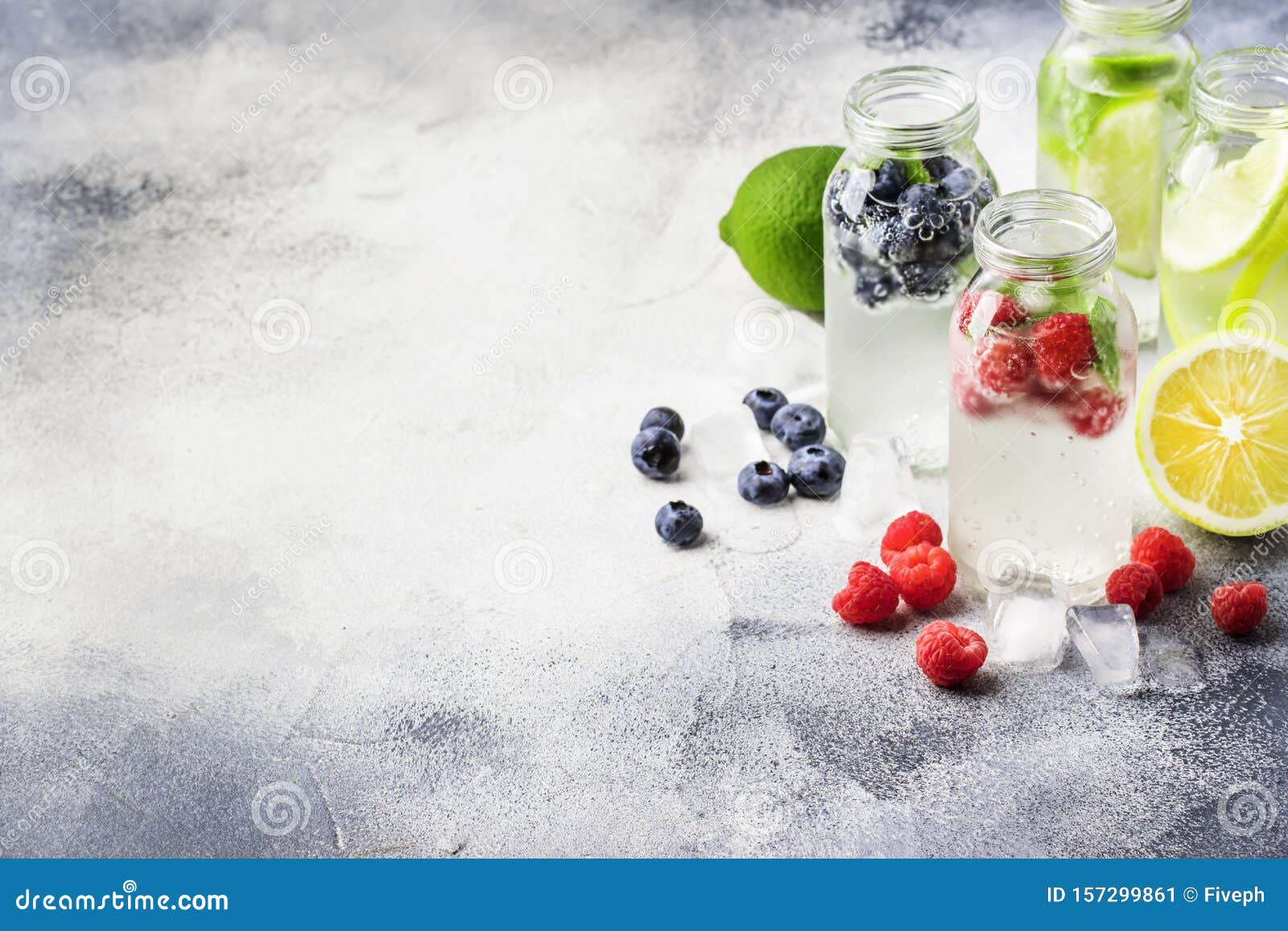 Berry and Citrus Soft Drinks and Cocktails in Glass Bottles on Gray Stone  Table Background, Copy Space Stock Image - Image of bottles, iced: 157299861