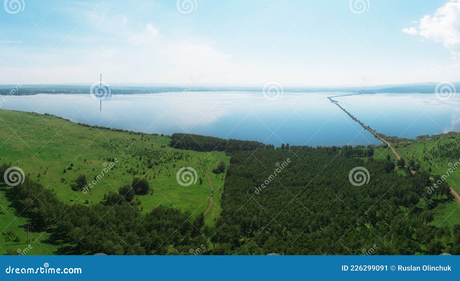 aerial drone view of lake landscape with road