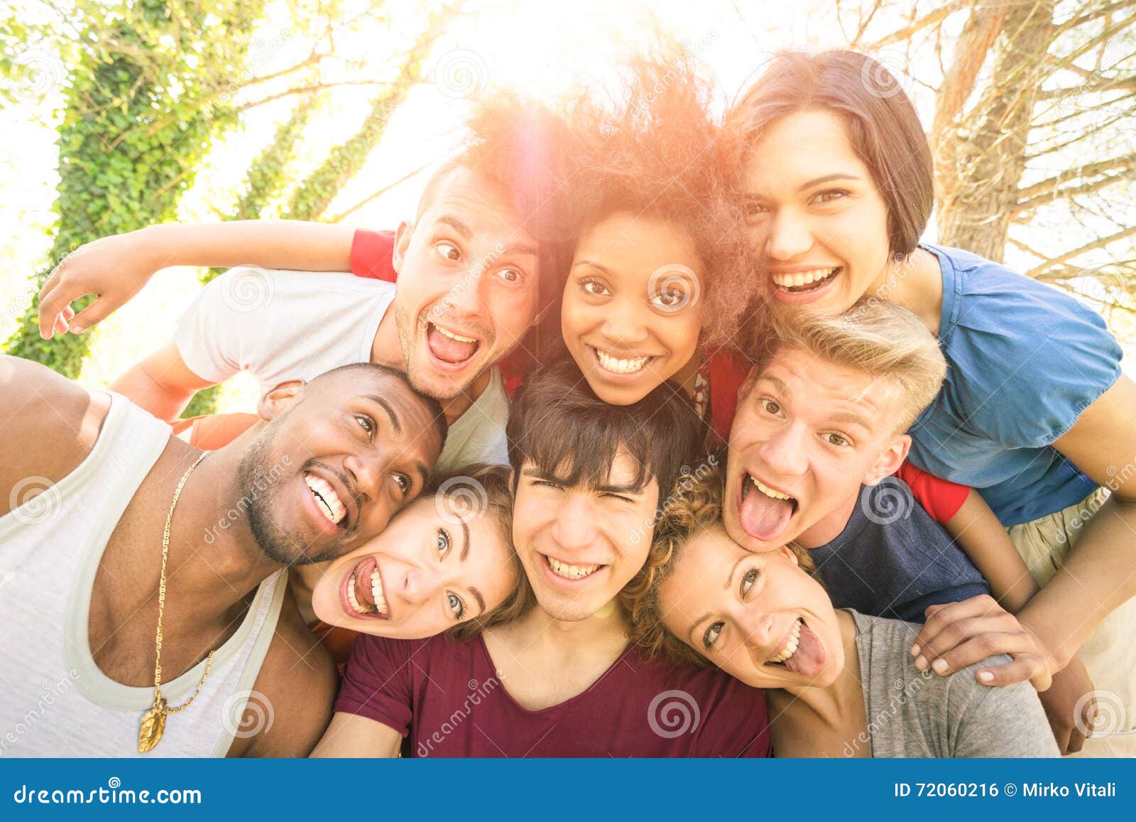 best friends taking happy selfie outdoor with back lighting