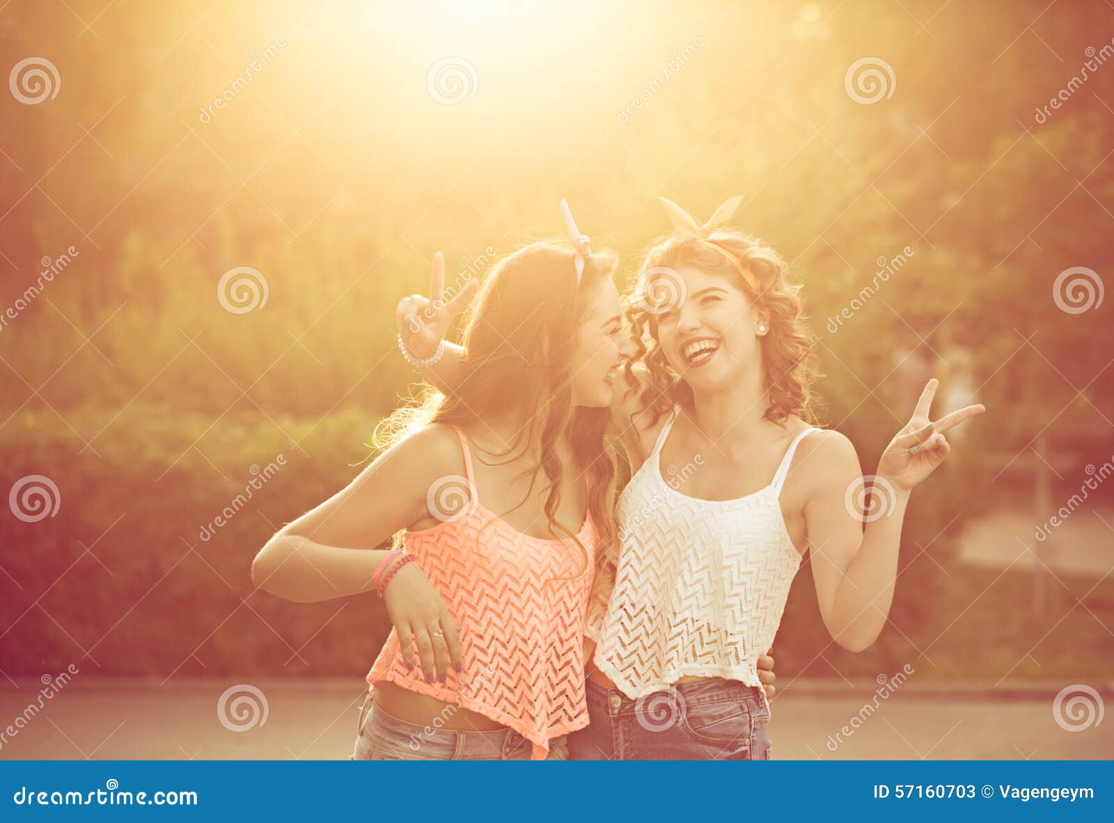 Best girlfriends hug. Sunset. Best girlfriends hug. Girls dressed in the style of Pin-up girl. Hipster. Warm toning. Sunset. The concept of true friendship.