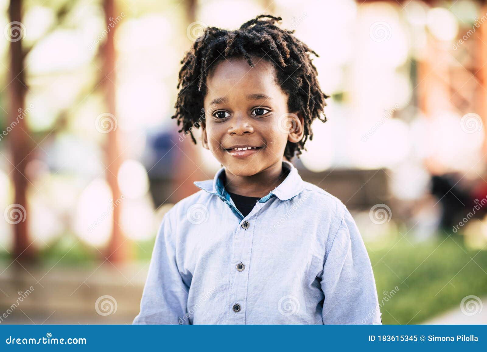 beutiful black african people children portrait with park outdoor defocused background - color and skin race diversity child