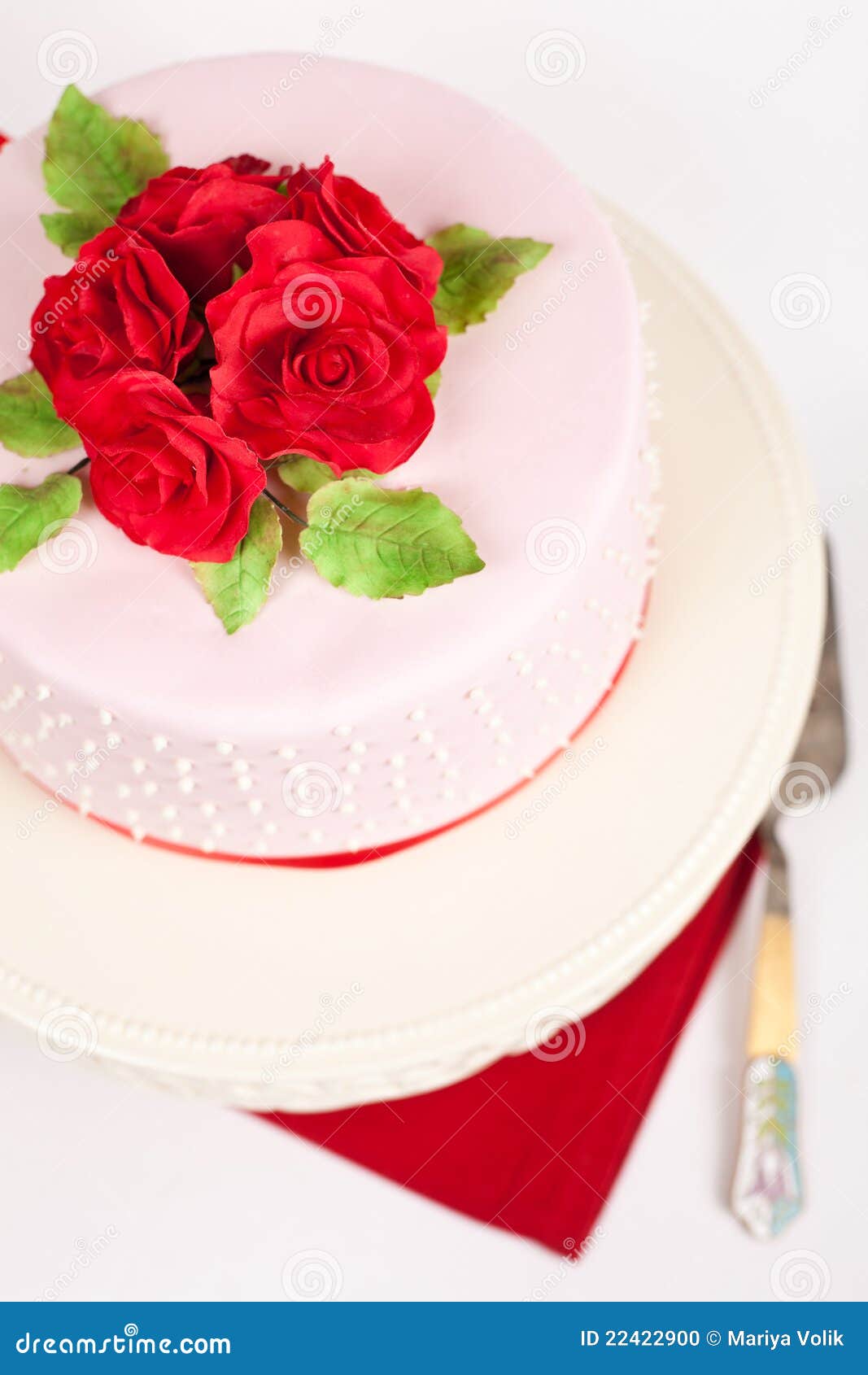 Bevlekte cake met rode rozen. Cake die met de bloemen van het suikerdeeg wordt verfraaid
