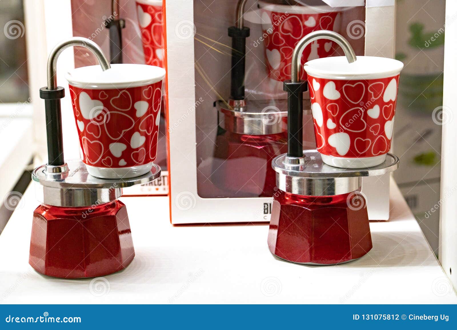 Coffee being served in a café with Bialetti espresso maker with two cups  and biscuit Stock Photo - Alamy