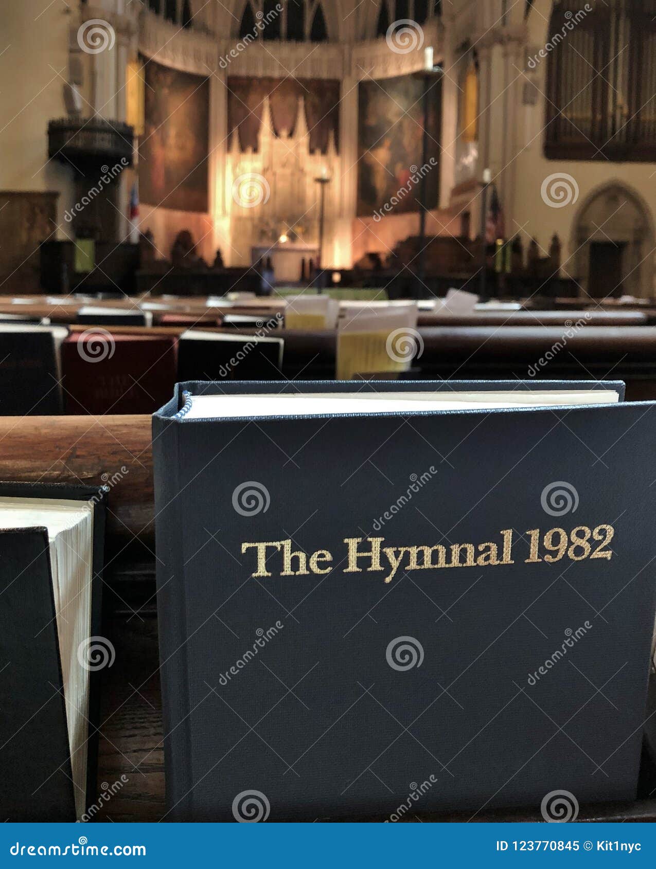 Bible Book Inside The Church Pew And Rows Of Bench Seating