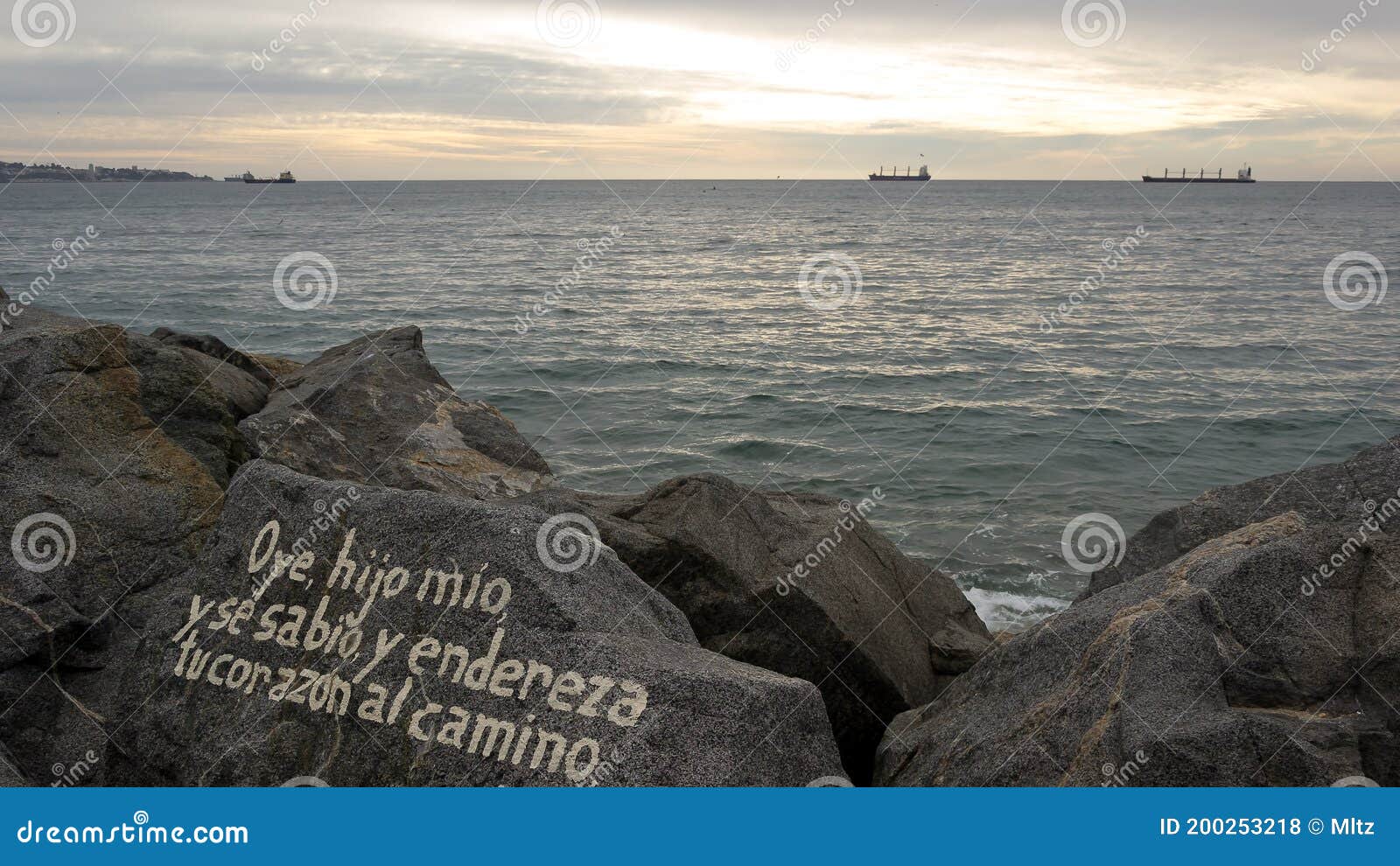 bible message in a rock at viÃÂ±a del mar beach, chileÃ¢â¬â¢s pacific ocean coast in a calm and beautiful sunset.