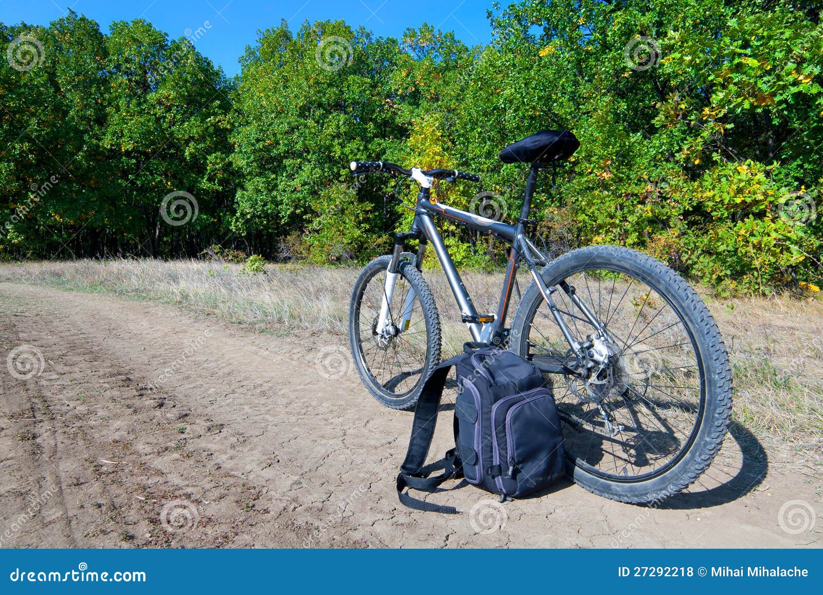 Bicycle and Backpack on a Road Near Forest Stock Photo Image of road