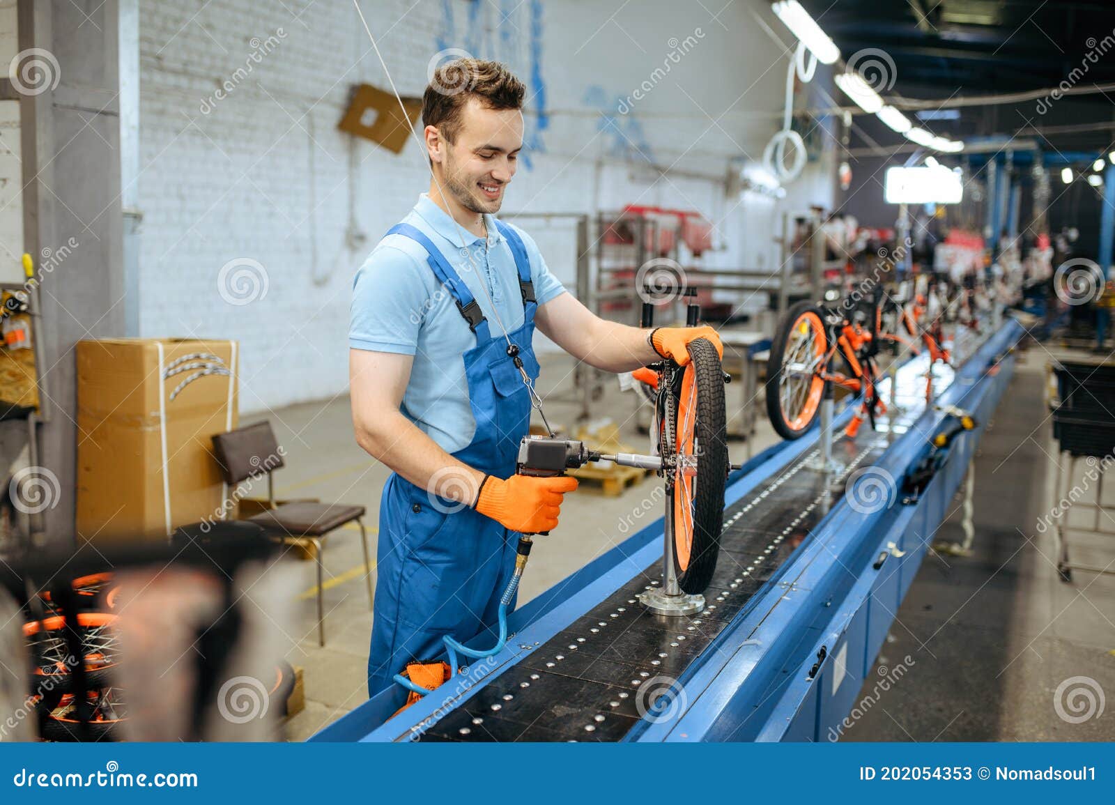 Bicycle Factory, Assembly Line, Chain Installation Stock Image - Bicycle Factory Assembly Line Chain Installation Worker Male Mechanic Uniform Installs Cycle Parts Workshop InDustrial 202054353