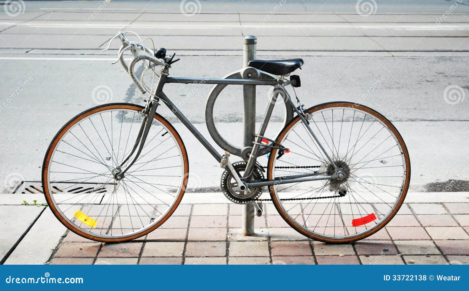 A Bicycle Locked Up on the Street Stock Photo Image of outdoors