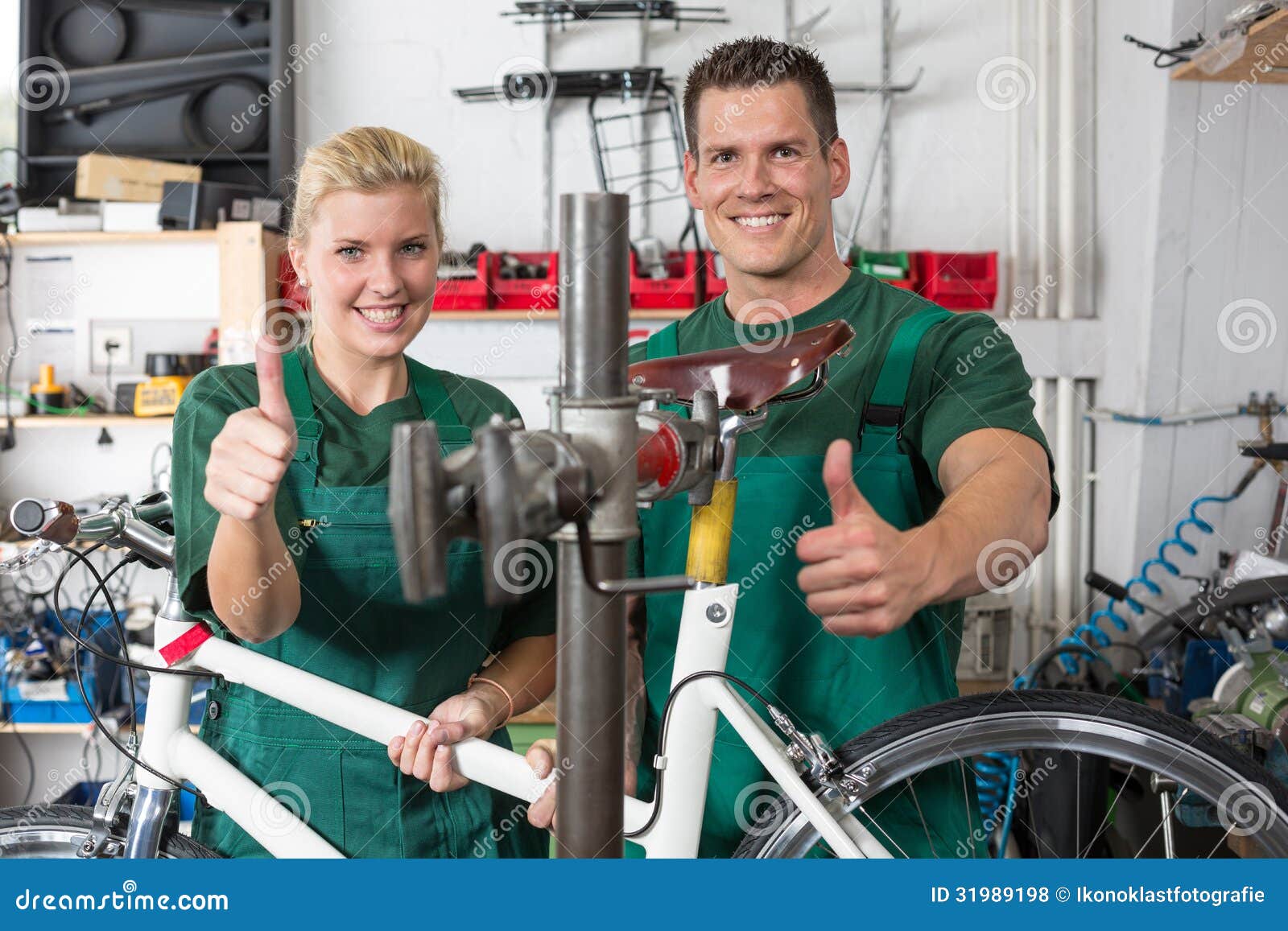 Bicycle Mechanic and Apprentice Repairing a Bike Stock Photo Image of serviceman, screwwrench