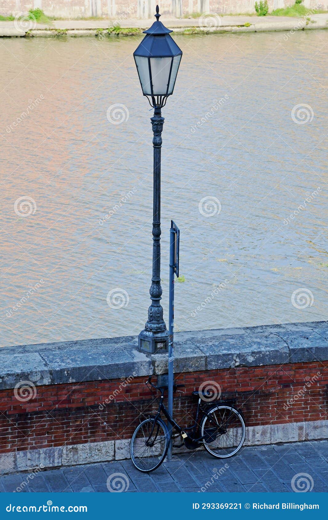 bicycle and old street lamp, river arno, tuscany, italy