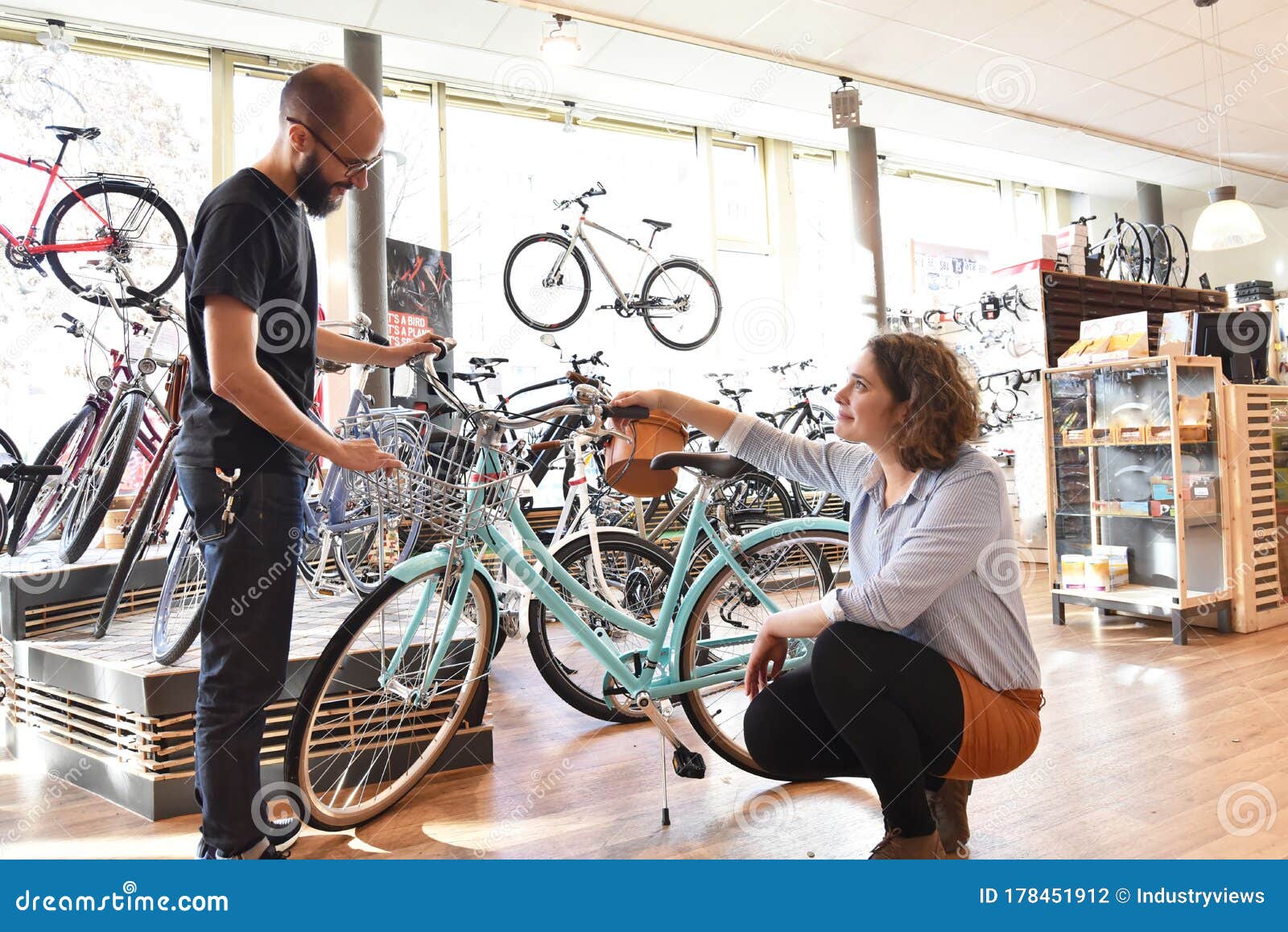 Bicycle Shop Consulting Salesman and Customer in Conversation Stock