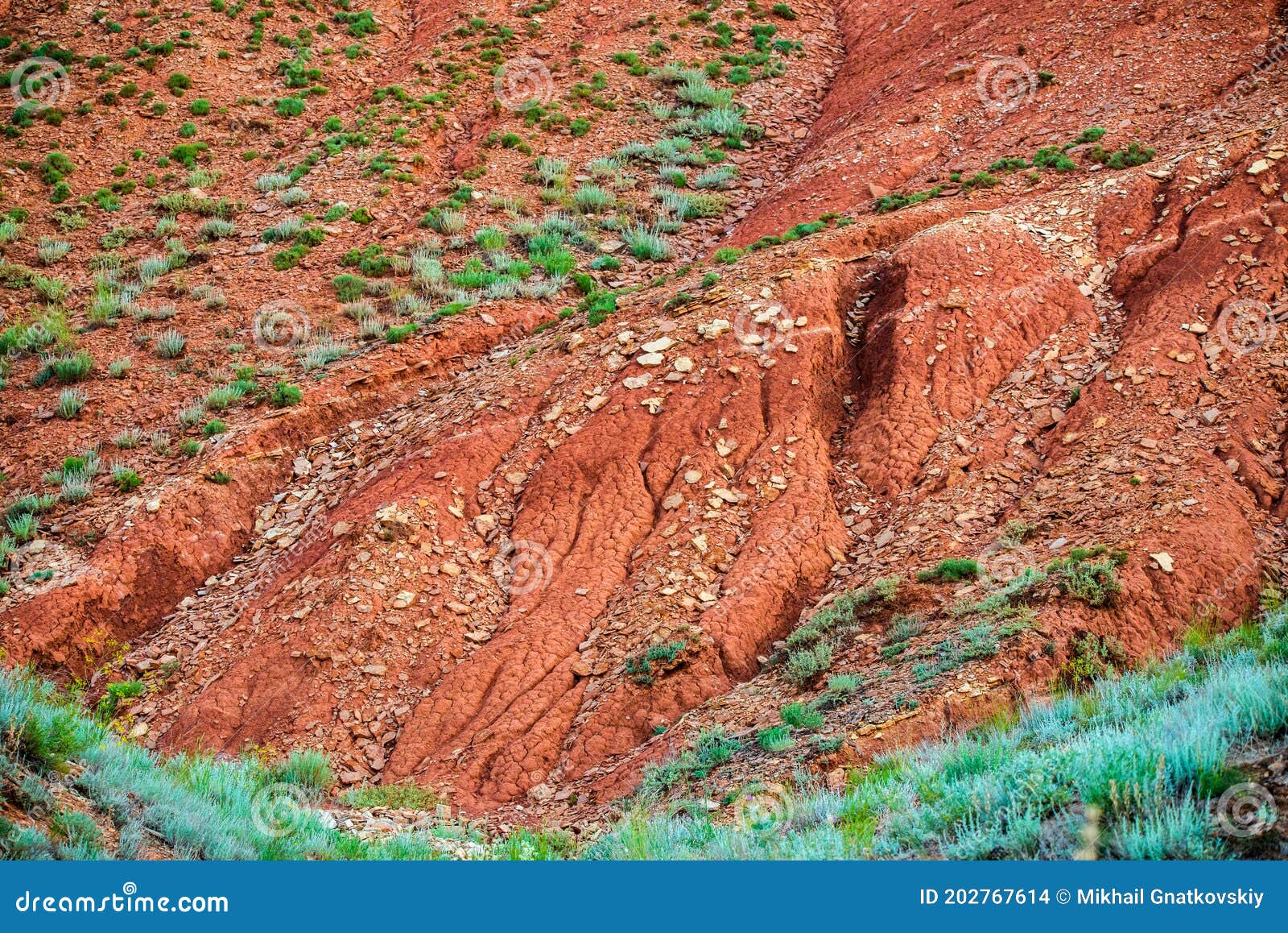 big bogdo mountain. red sandstone outcrops on the slopes sacred mountain in caspian steppe bogdo - baskunchak nature reserve,