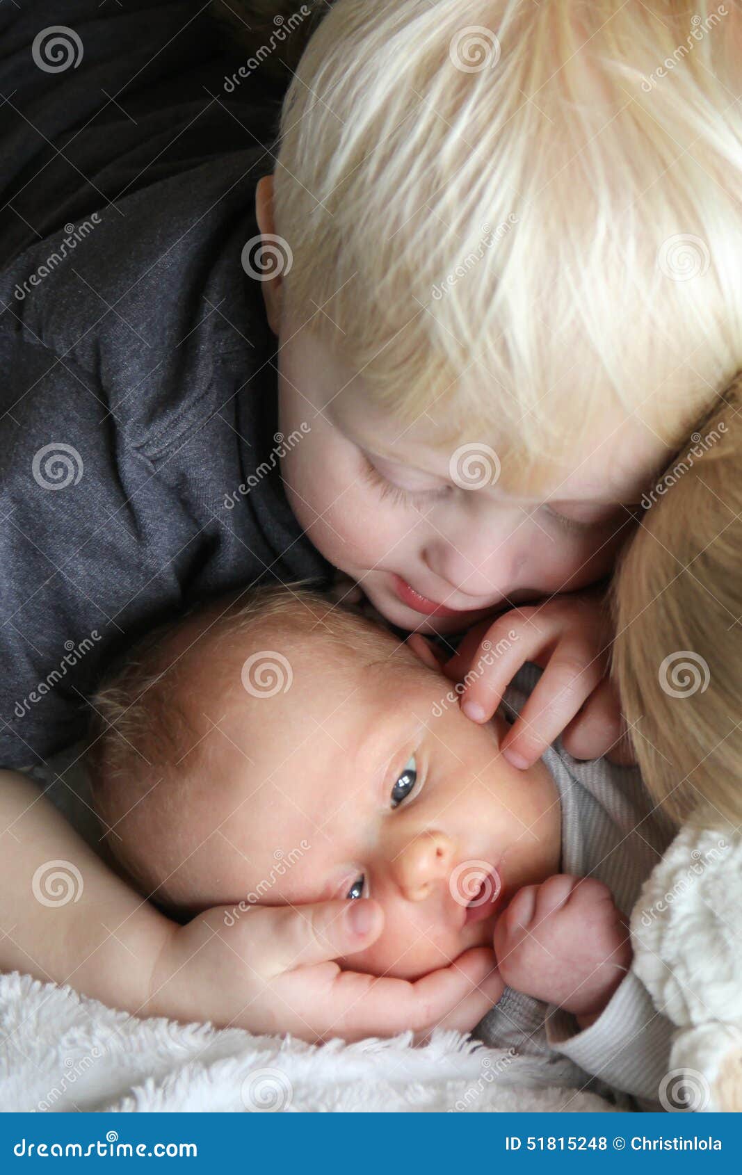 Big Brother Looking at Newborn Baby with Love Stock Photo - Image ...