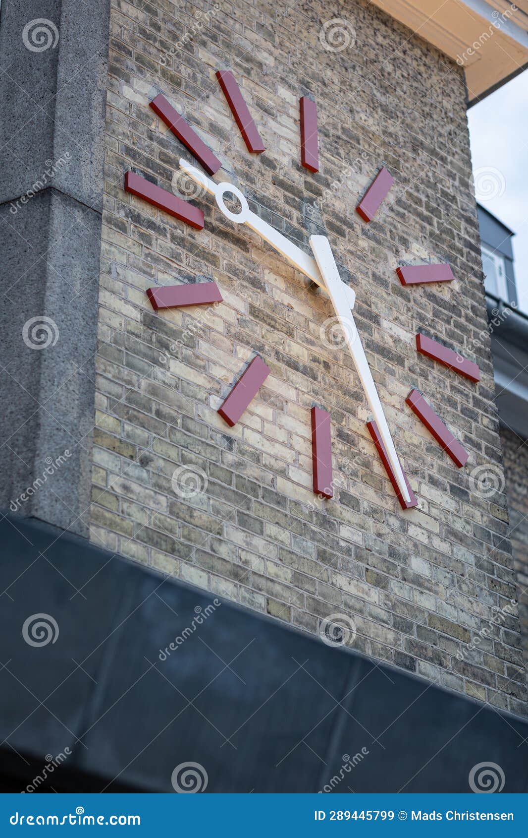 Big Clock Watch on Yellow Brick Wall, Lit Up in the Evening Stock Image