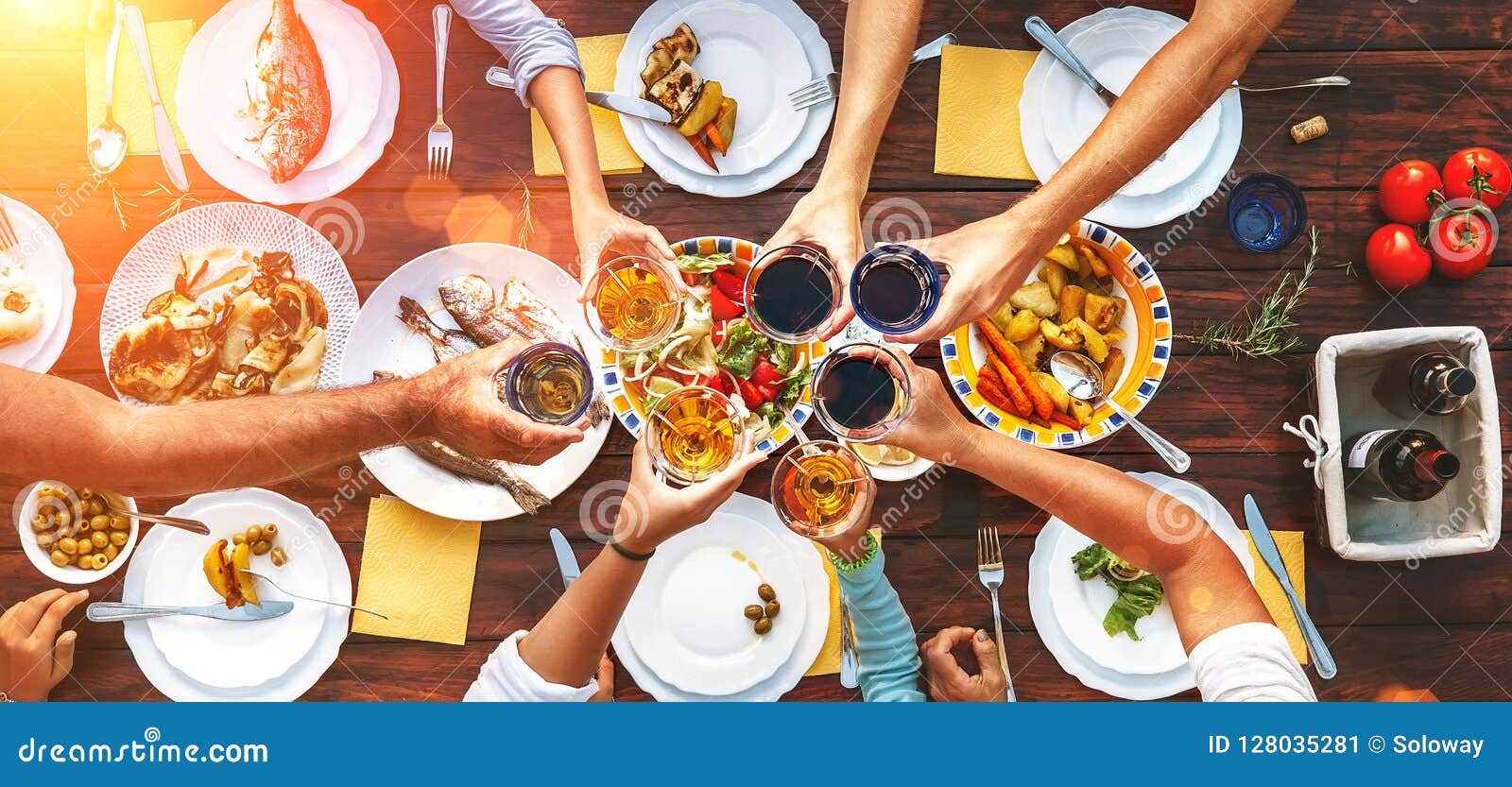 big family dinner. vertical top view on served table and hands w