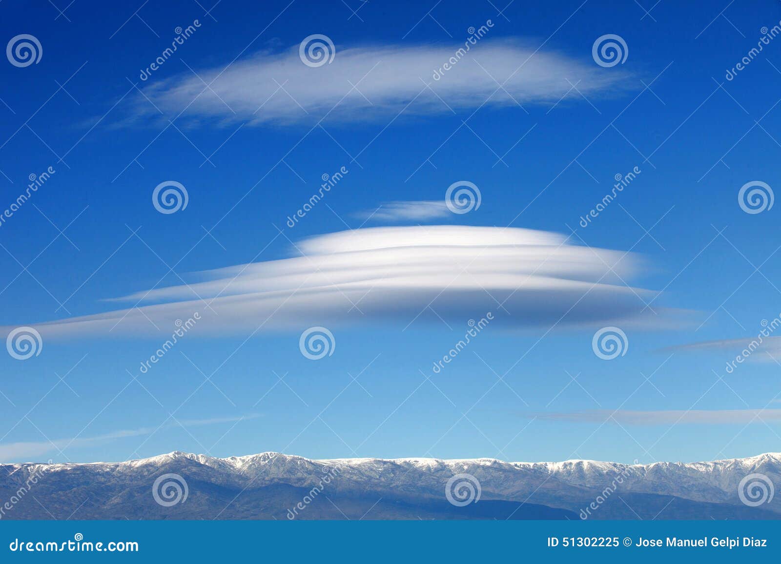 big lenticularis cloud and snowed mountain