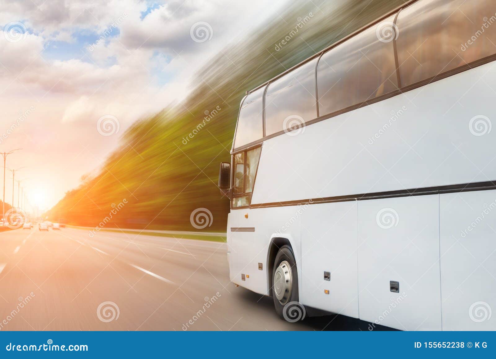 big luxury comfortable tourist bus driving through highway on bright sunny day. blurred motion road. travel and coach