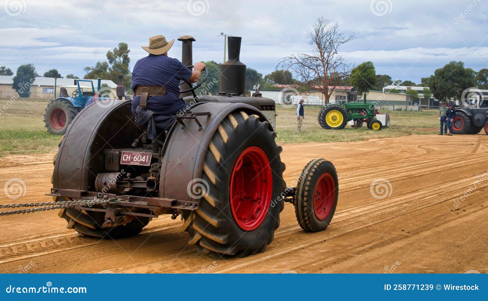 Big Old Black Tractor Pulling the Sled in a Tractor Pull Event
