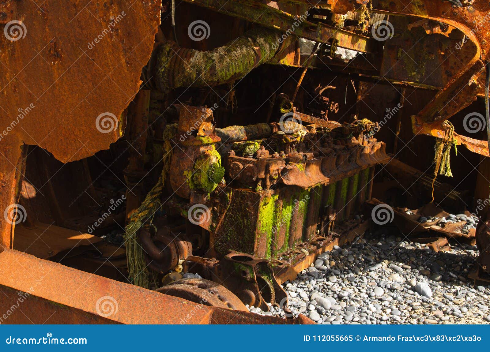 rusted engine of a wrecked pusher boat