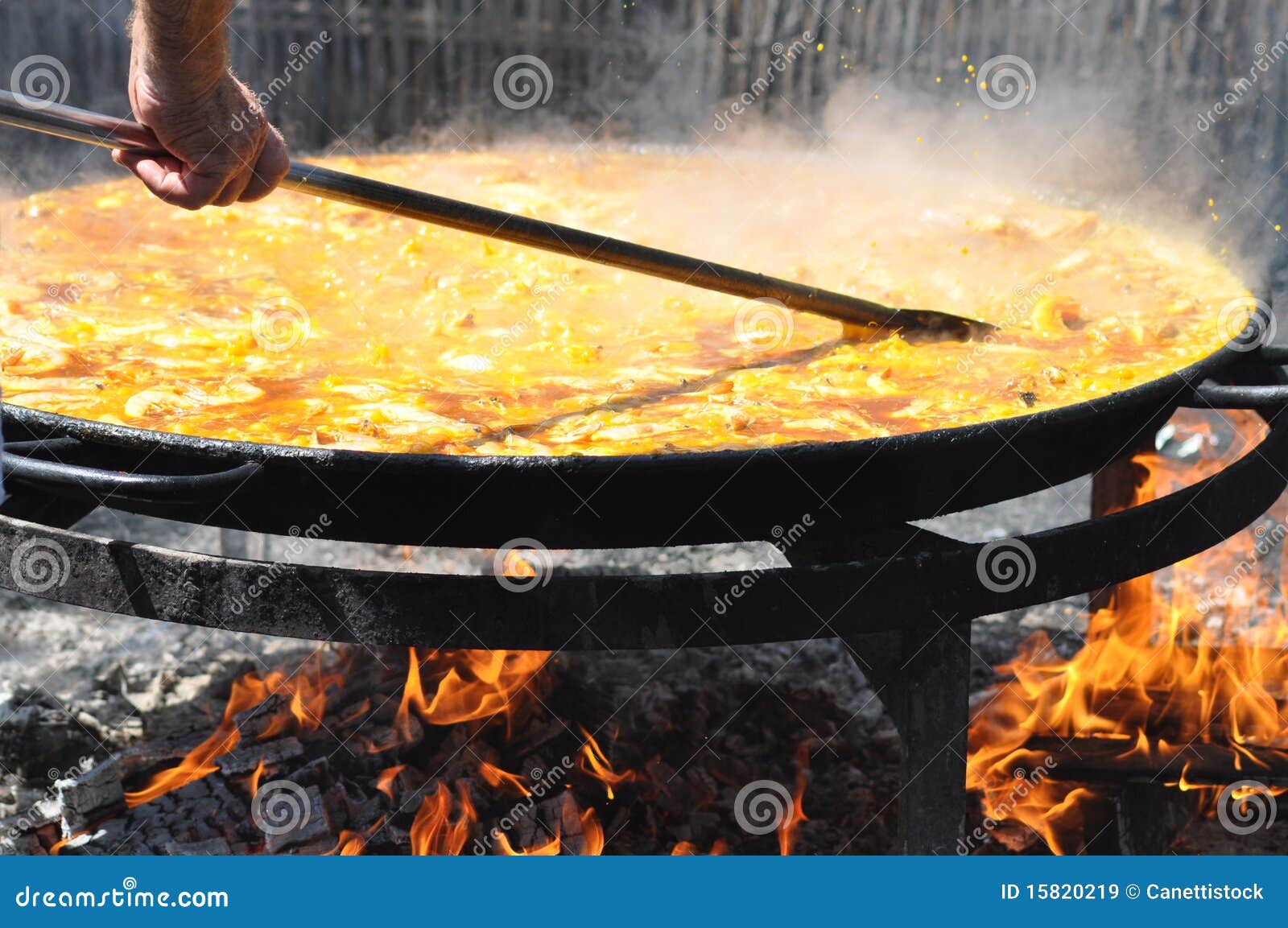 Huge Pan Of Paella At A Italian Festival People Preparing Portions RoyaltyFree Stock Photo