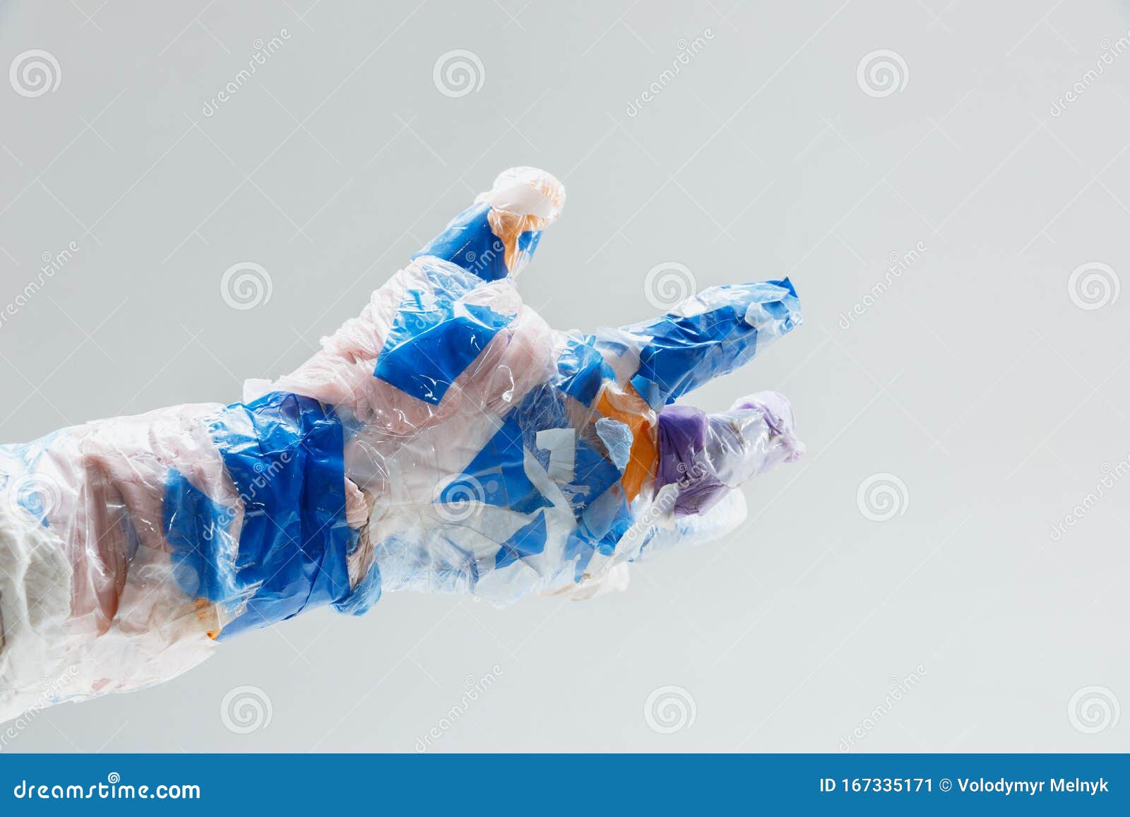 big plastic hand made of garbage  on white studio background