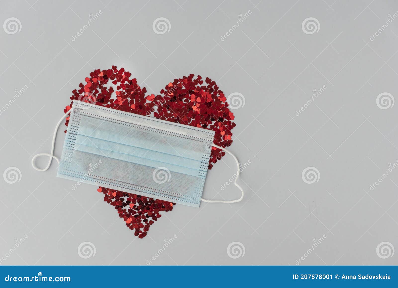 big red heart made from little glittering confeti partly covered with medical mask, protective measures on valentines day, new rea